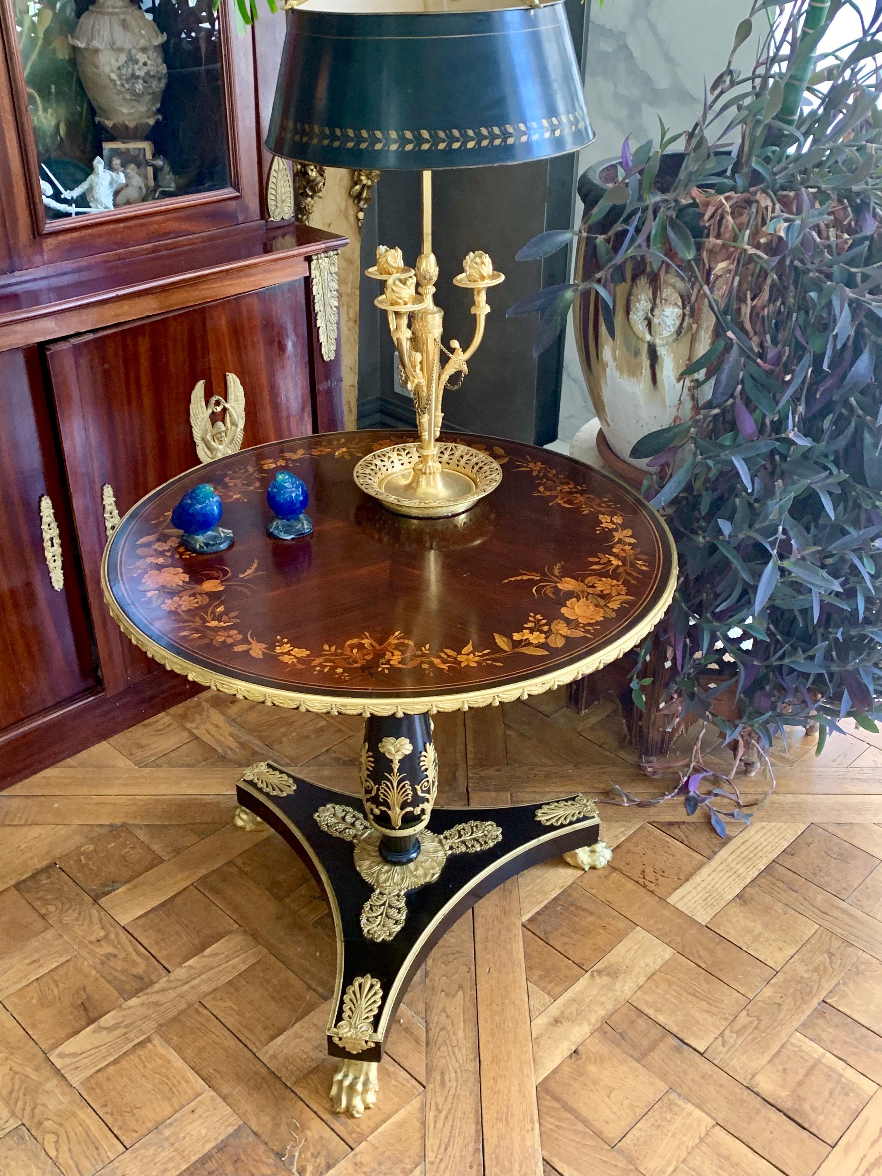 A fine example of Herts Brother's high quality craftsmanship. This round side table is raised on three hairy paw ormolu feet which has a heavily ormolu encrusted platform out of which a column rises to support the finely inlaid top of flower