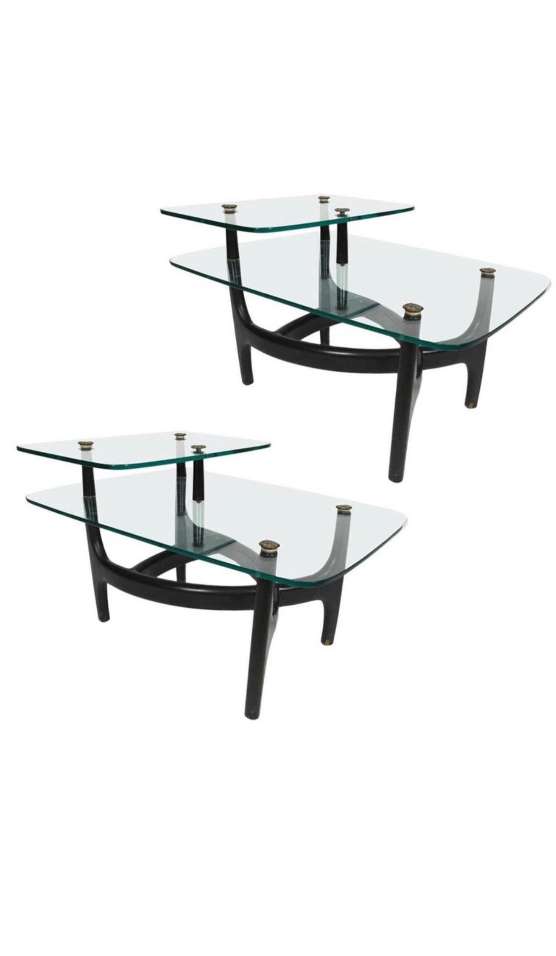 An elegant pair of MCM Side Tables handcrafted of ebonised hardwood. The two-tier design is clearly inspired by Vladimir Kagan and Adrian Pearsall. 
The biomorphic design is connected by Wooden columns.
The surface is original and has been