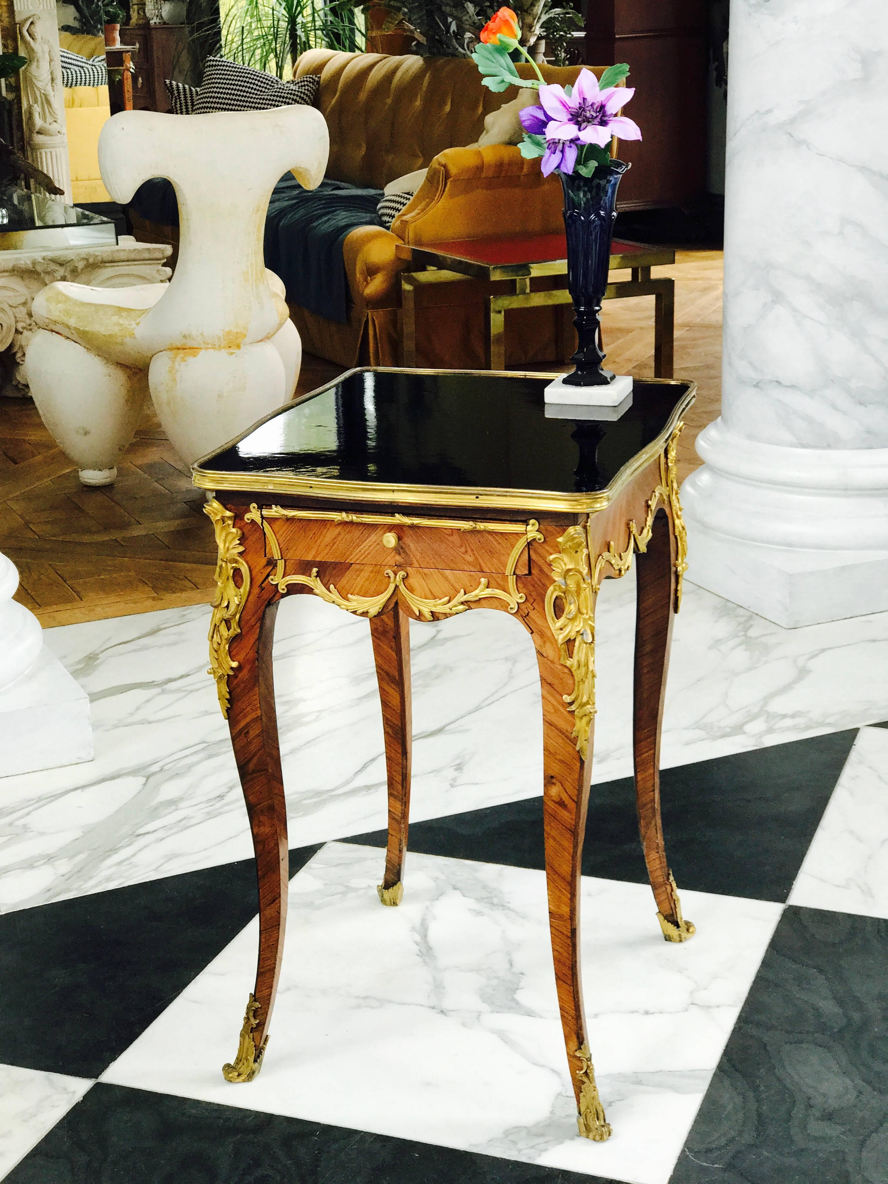 This Period Louis XV side table was made ca 1760, the kingwood veneers are all original and so are the thickly gold plated hand chased bronze mounts, which grace all four sides, so the table can be free-standing. 
The proportions are perfection and