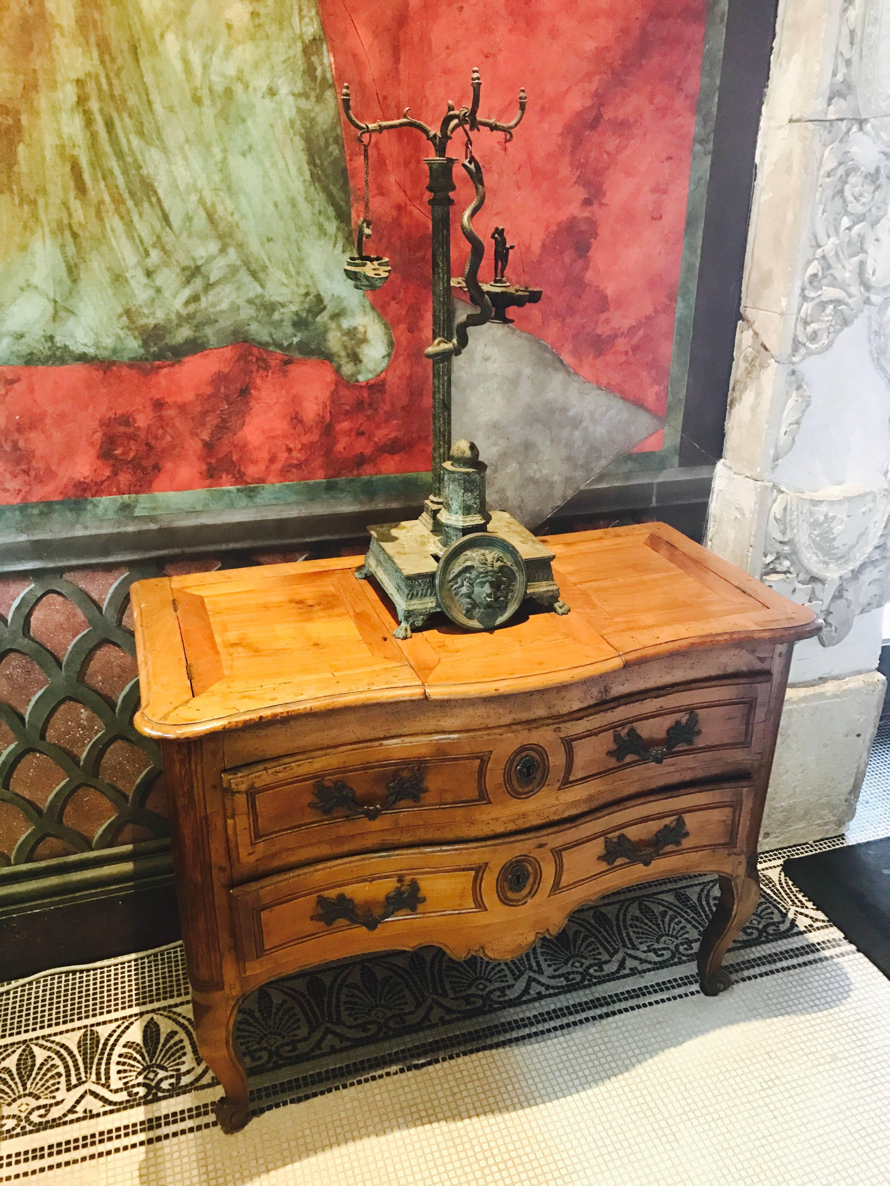 Here is a very rare example of a oil-burning table lamp that was taken from a Pompeiian Original. The workmanship and Patina fool the eye, since it is a true representation of a buried treasure 2000 years old.
At the turn of the century Andrew