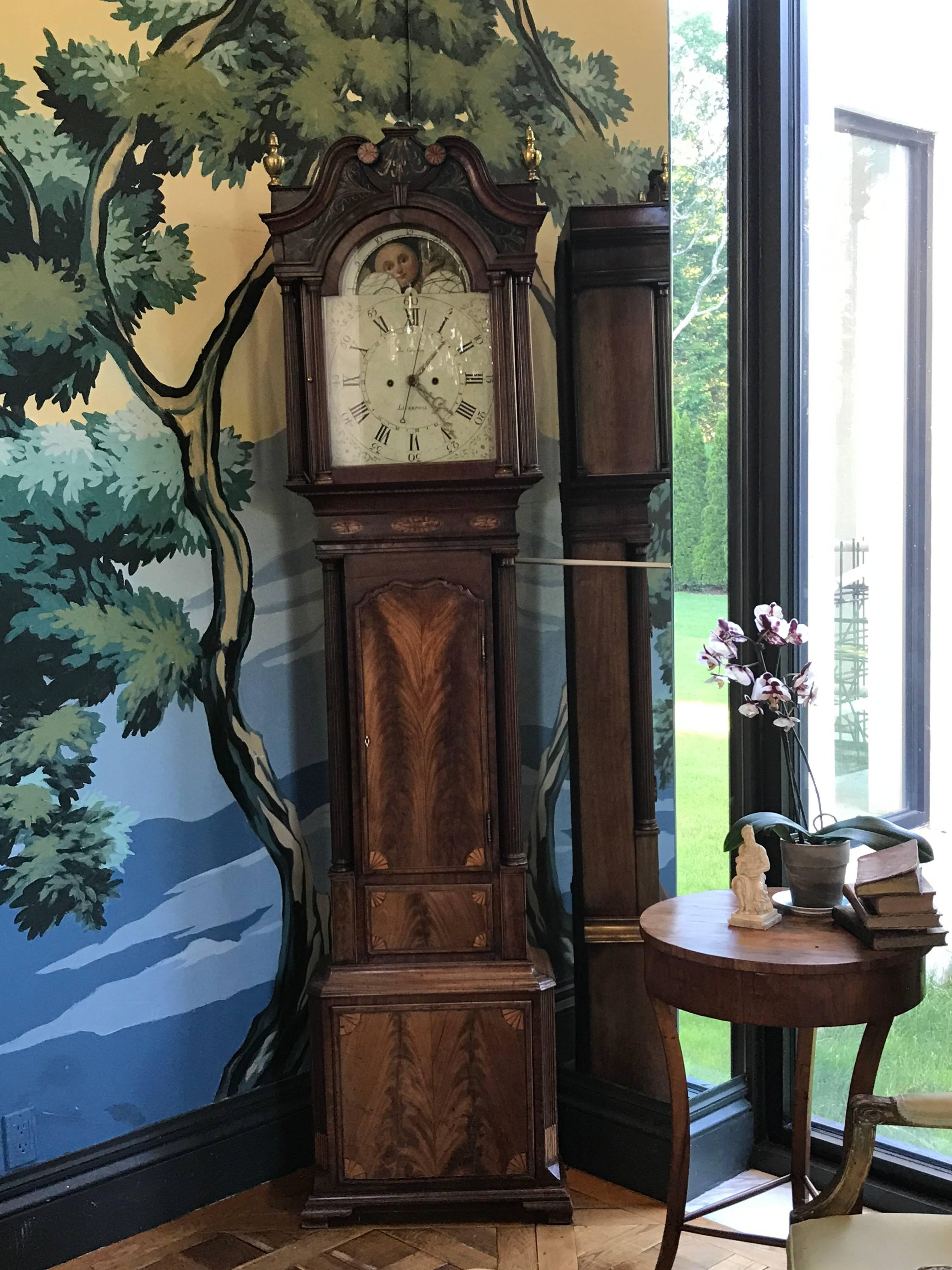 This elaborately decorated tall case clock, dating from the mid-18th century by Clockmaker James Cawson from Liverpool, has all the bells and whistles the Chippendale period has to offer.
The case is made of bookmatched mahogany with contrasting