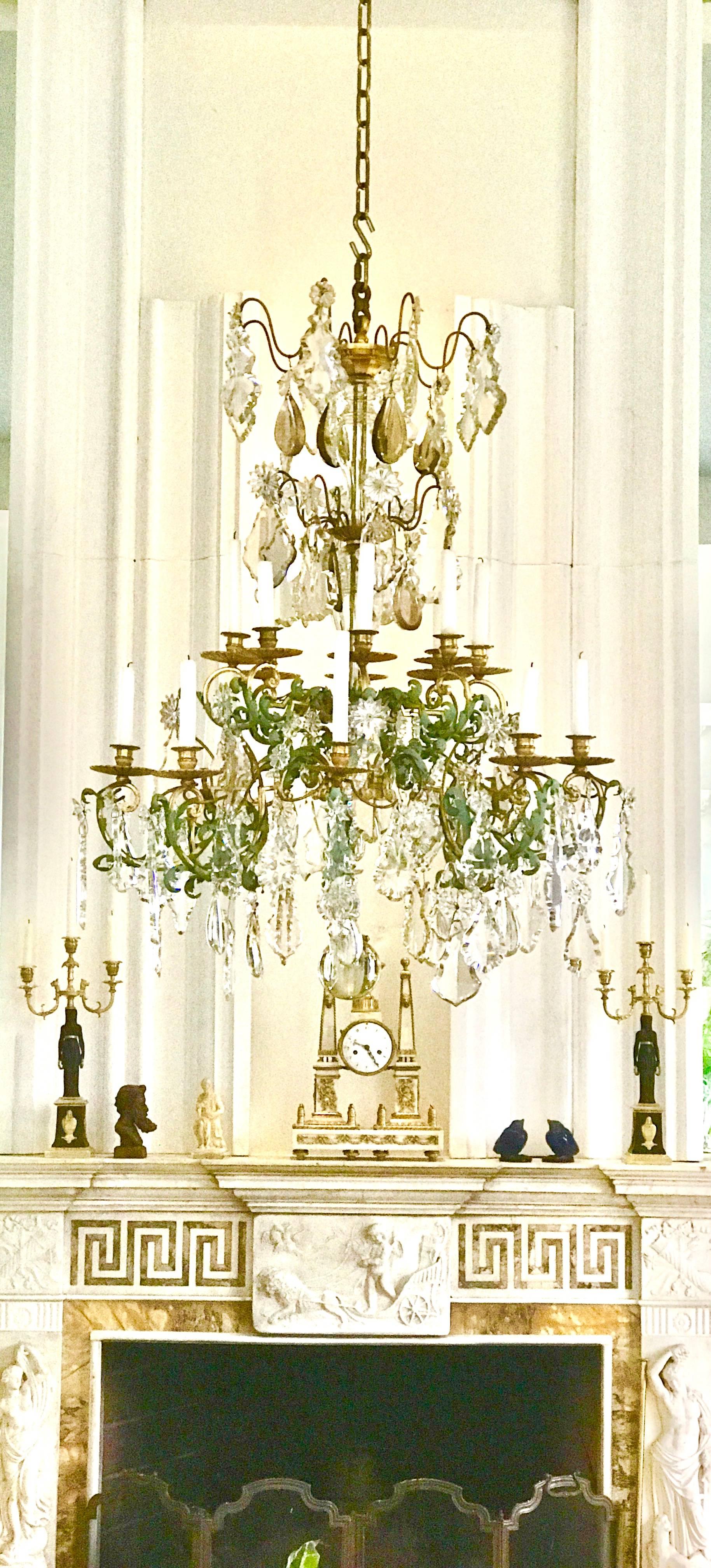 This Baccarat style chandelier came from a fine Palm Beach Estate and is of supreme quality.
It is made of 16 solid gilt bronze arms and retains it's original hand-cut crystal pendants in multiple shapes some of them are made of smoked crystal and