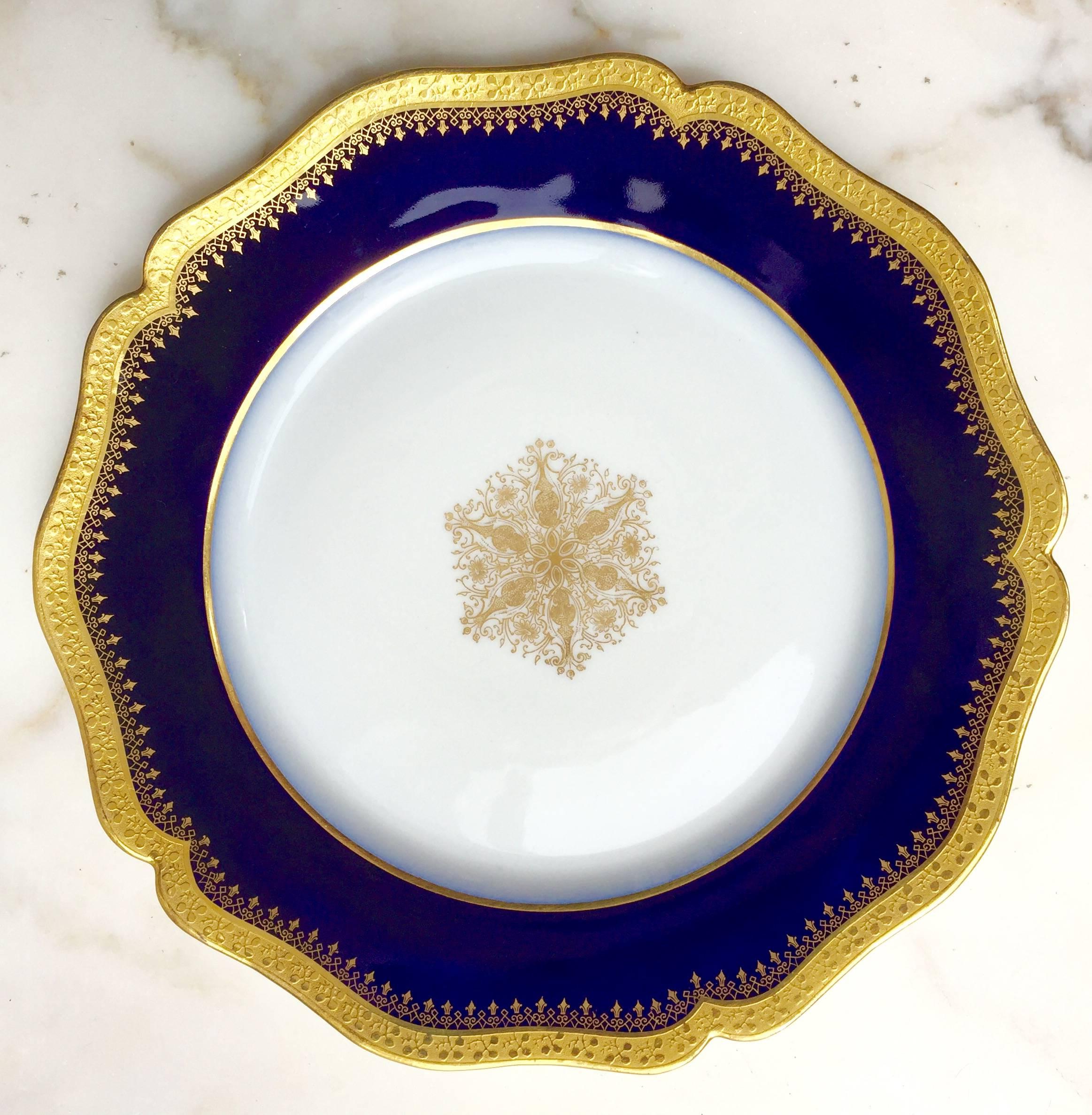 These 12 Bone China luncheon/salad/dessert plates have a bold deep cobalt blue border outlined in encrusted 24-karat gold. The gold central medallion is also in pristine condition. They are manufactured by Limoges, France.