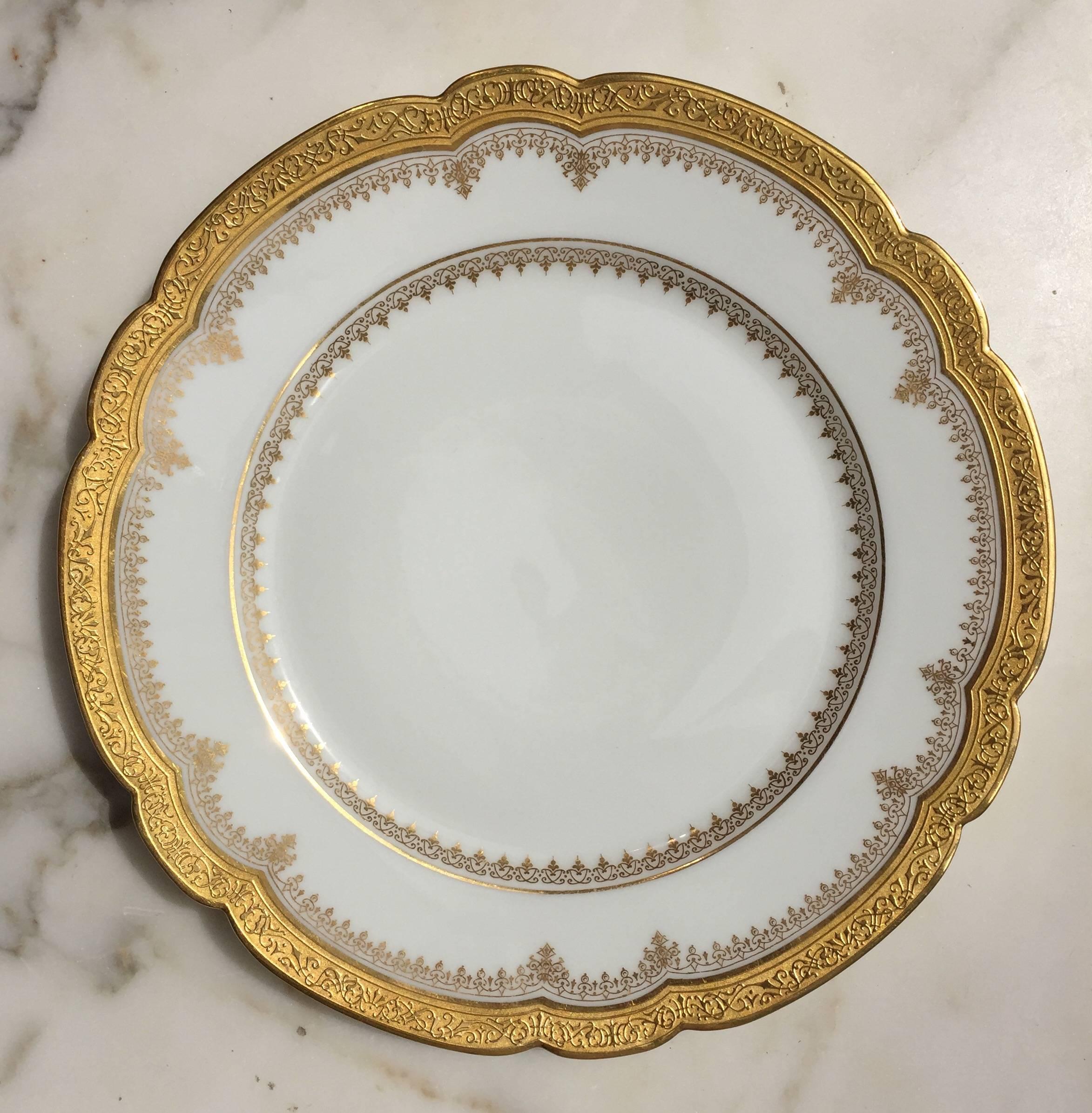 This pristine set of 12 Bone China Luncheon Plates have a scalloped edge encrusted in 24-karat gold relief, as well as two more delicate gilt patterns, see image #4.
The backside is signed in cursive script in gold 