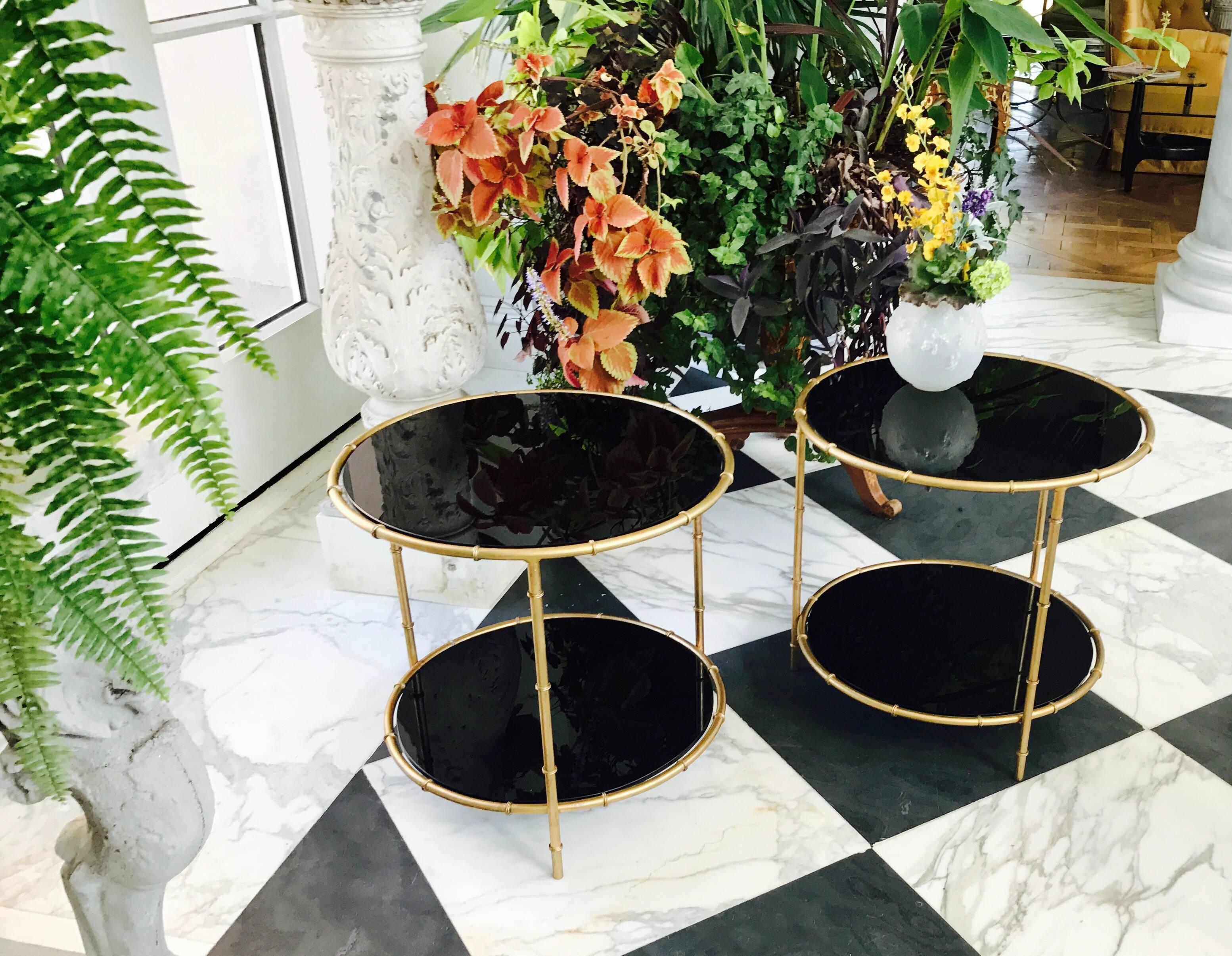 This Jansen inspired Pair of Side Tables comes with 2 tiers of onyx black glass tops. 
Standing on 3 hand made 3 made bamboo inspired gilt iron legs.

Made ca 1960 in France.