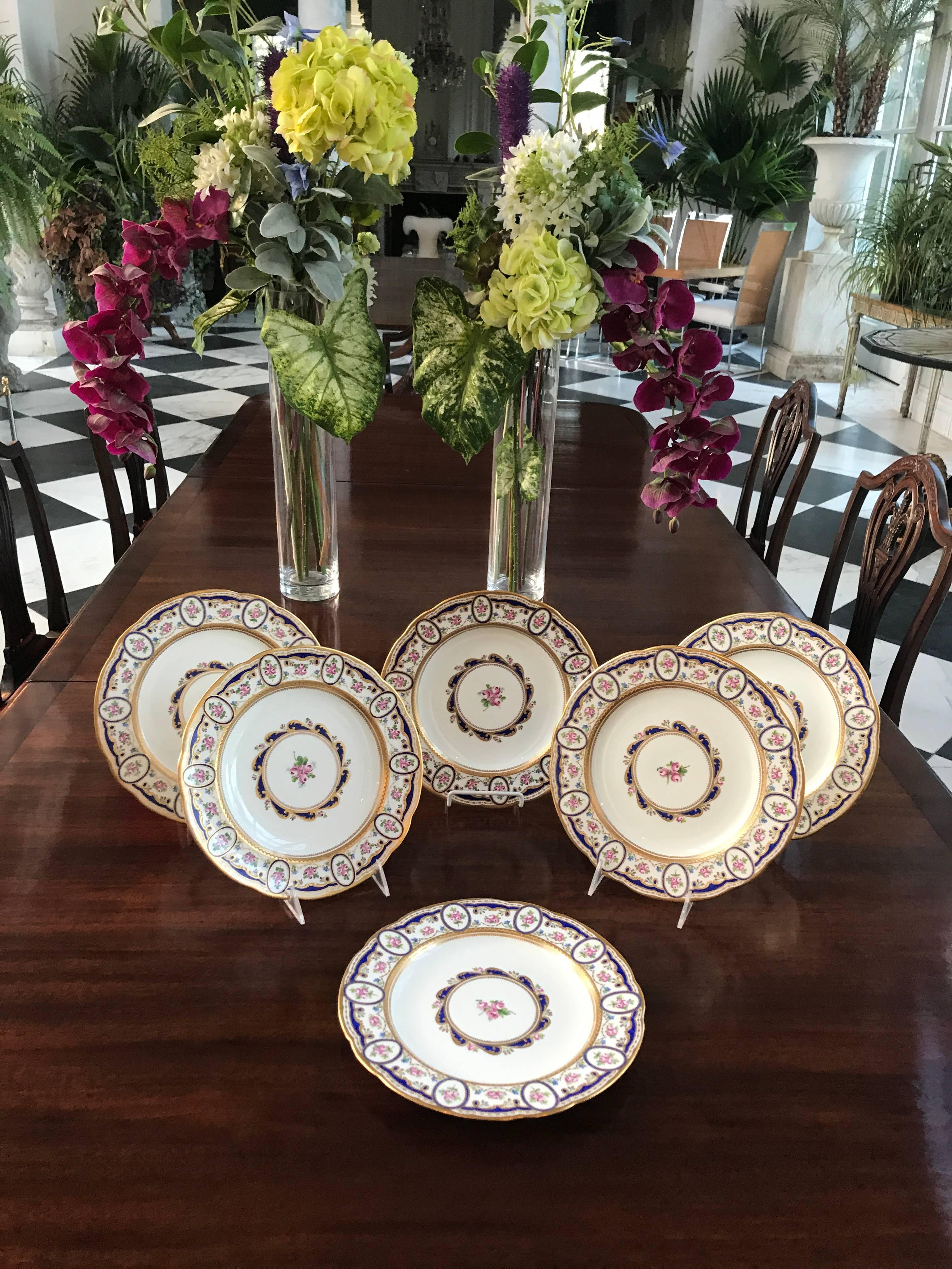 This breath-taking and rare Set of six Dinner Plates was manufactured by France's best Porcelain manufacturer Sèvres in the late 19th century. 
The surface is elaborately decorated in jewel tones, the pink rose bundles are framed in ovals around the