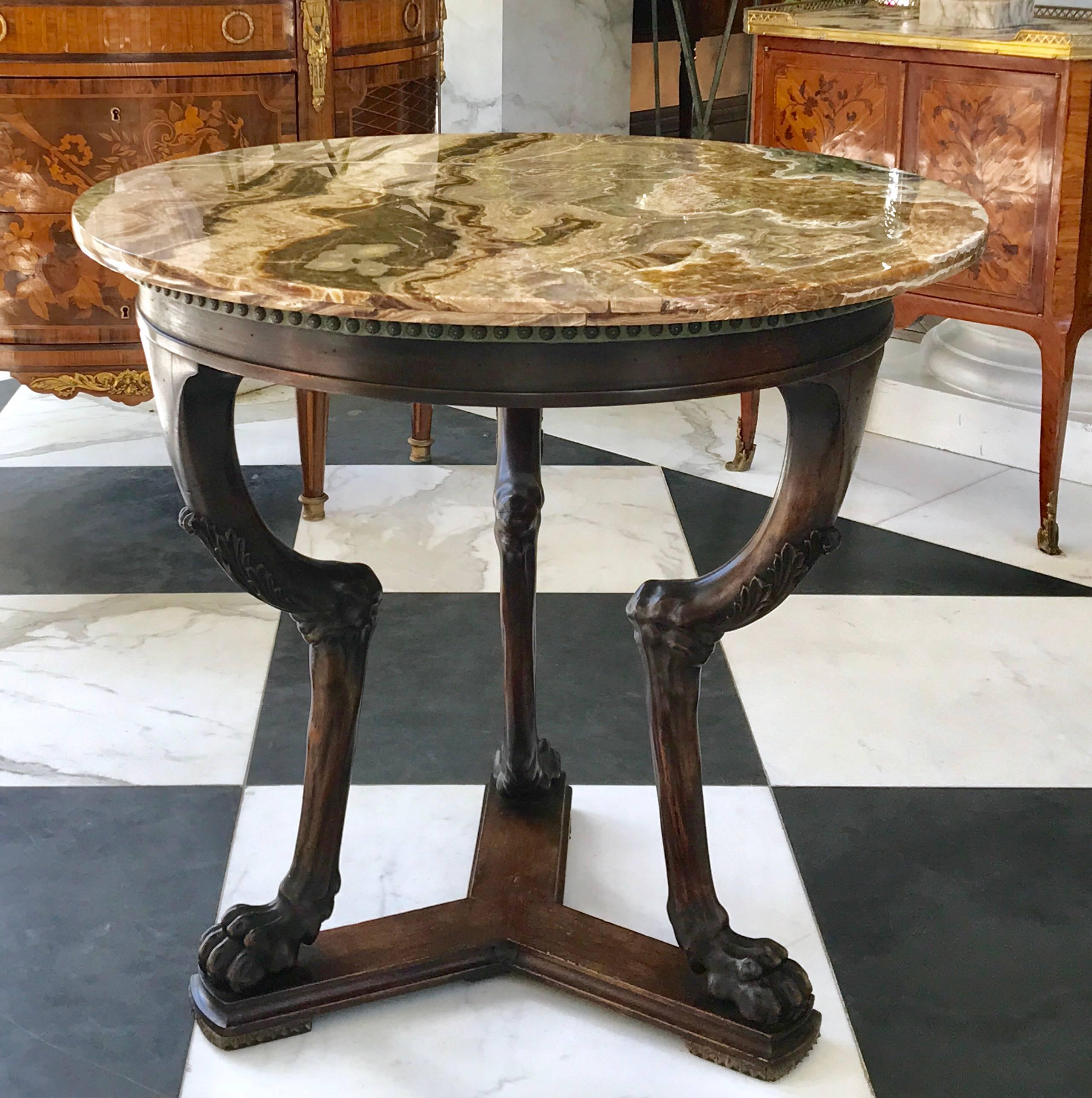 This extraordinary neoclassical side table is hand carved in the mid 19th century in Italy. Made of walnut with a rare deep amber onyx top that will catch the eye of anyone.
The elegance of this table is outstanding! 
Made in Italy ca 1840