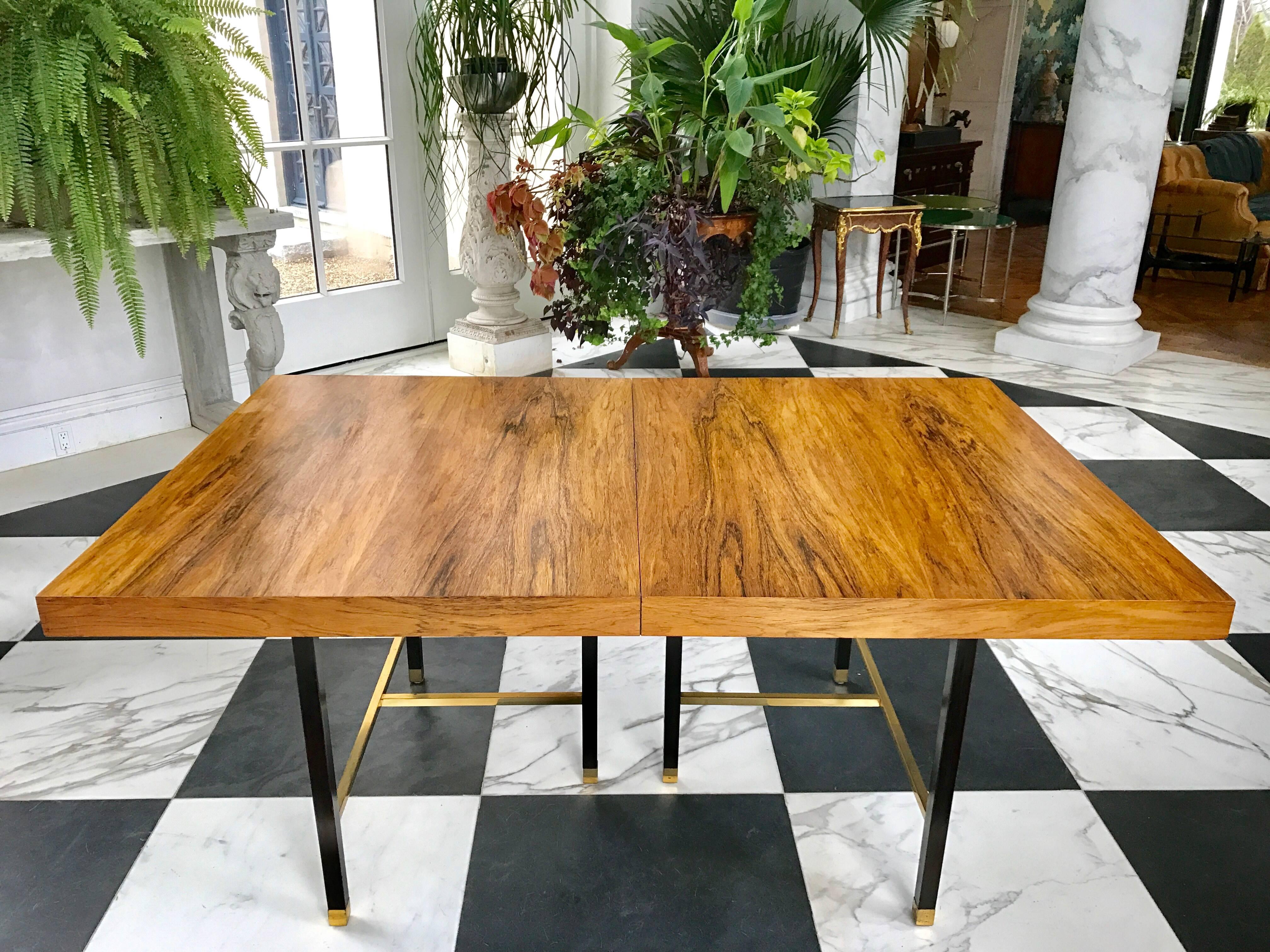 This striking rosewood dining table has a dark mahogany base.
Two 16