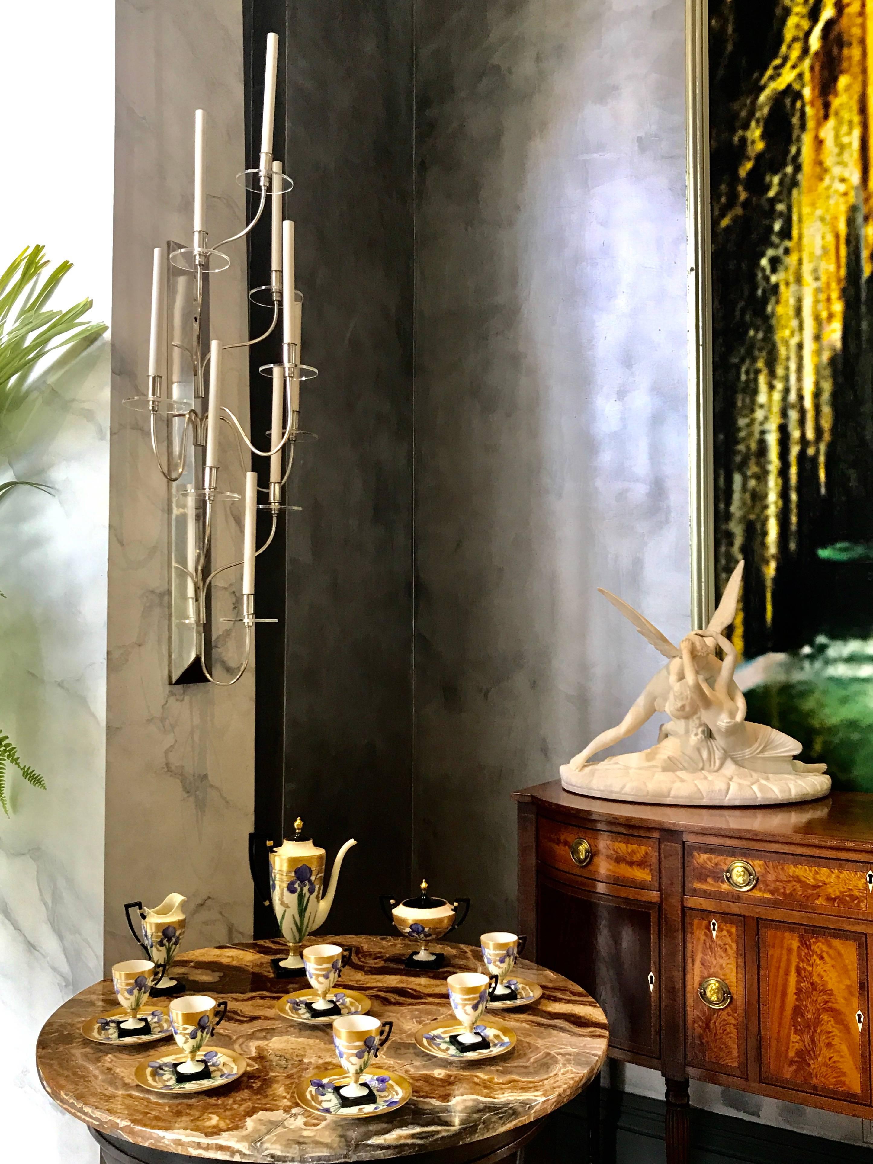 This exquisite Pair of silver plated Wall Sconces is sophisticated and stylish as one expects to see in Tommi Parzinger's work.

Clear glass candle saucers and the tall candle sleeves compliment the most elegant design of these Wall Scones,