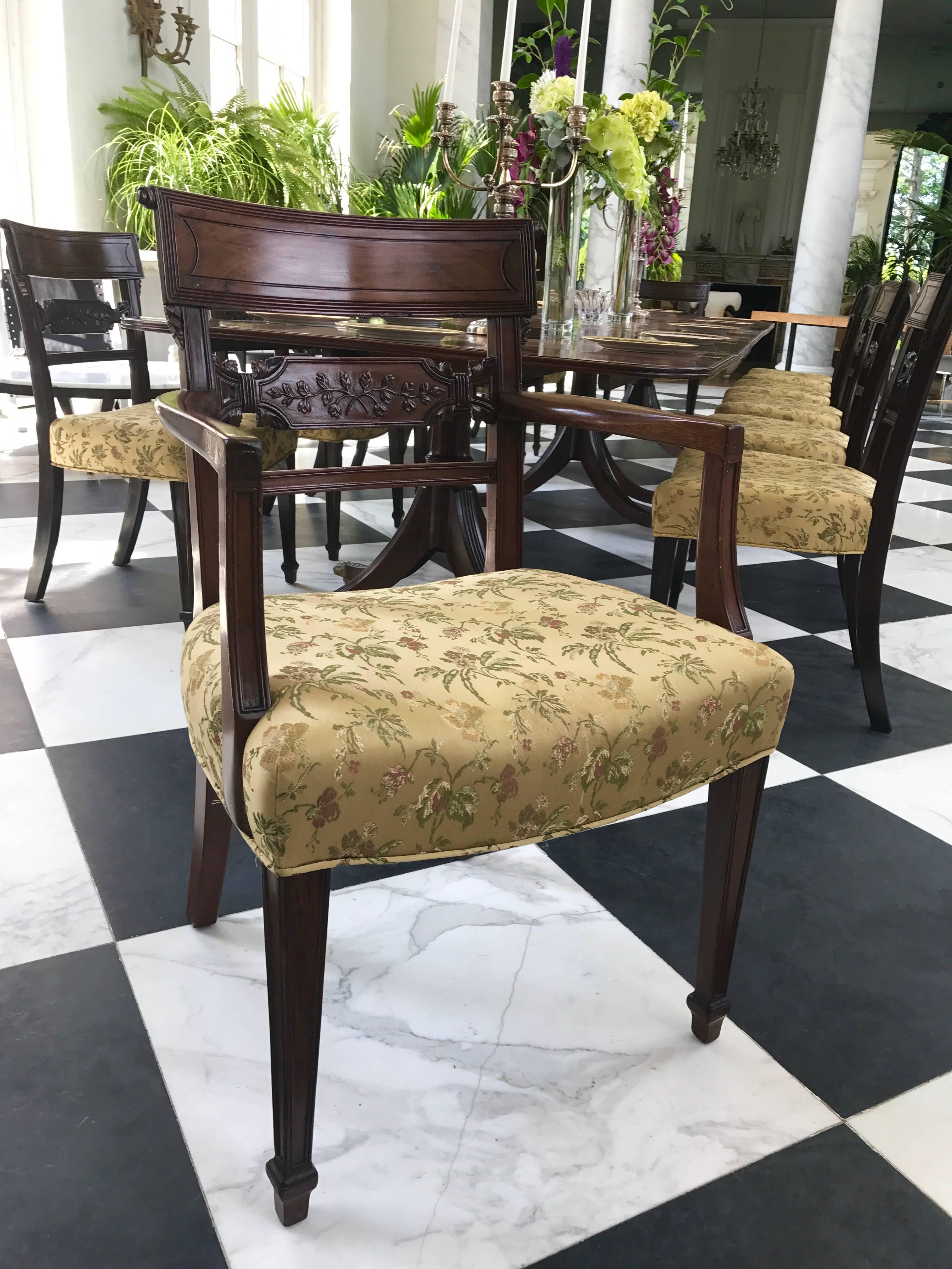 This gorgeous Set of 12 Regency period Dining Chairs has incredibly detailed hand carved backs of foliate design. 
They are made of the finest mahogany, Cuban mahogany, deep and rich in color.
The legs are tapered with reeding on the edges. 
There