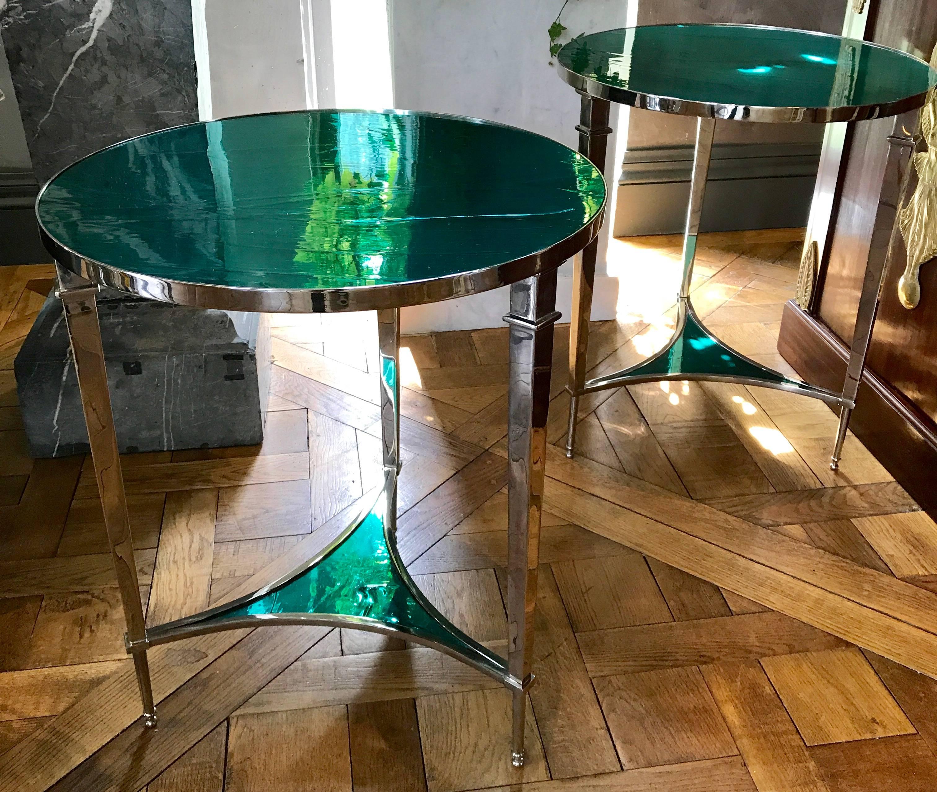 This gorgeous pair of nickel-plated side tables in the neoclassical style is a limited edition set of only 5 sets. The Emerald green hand blown mirrored glass top's and lower shelfs are handmade and custom fitted.
Made in the US.