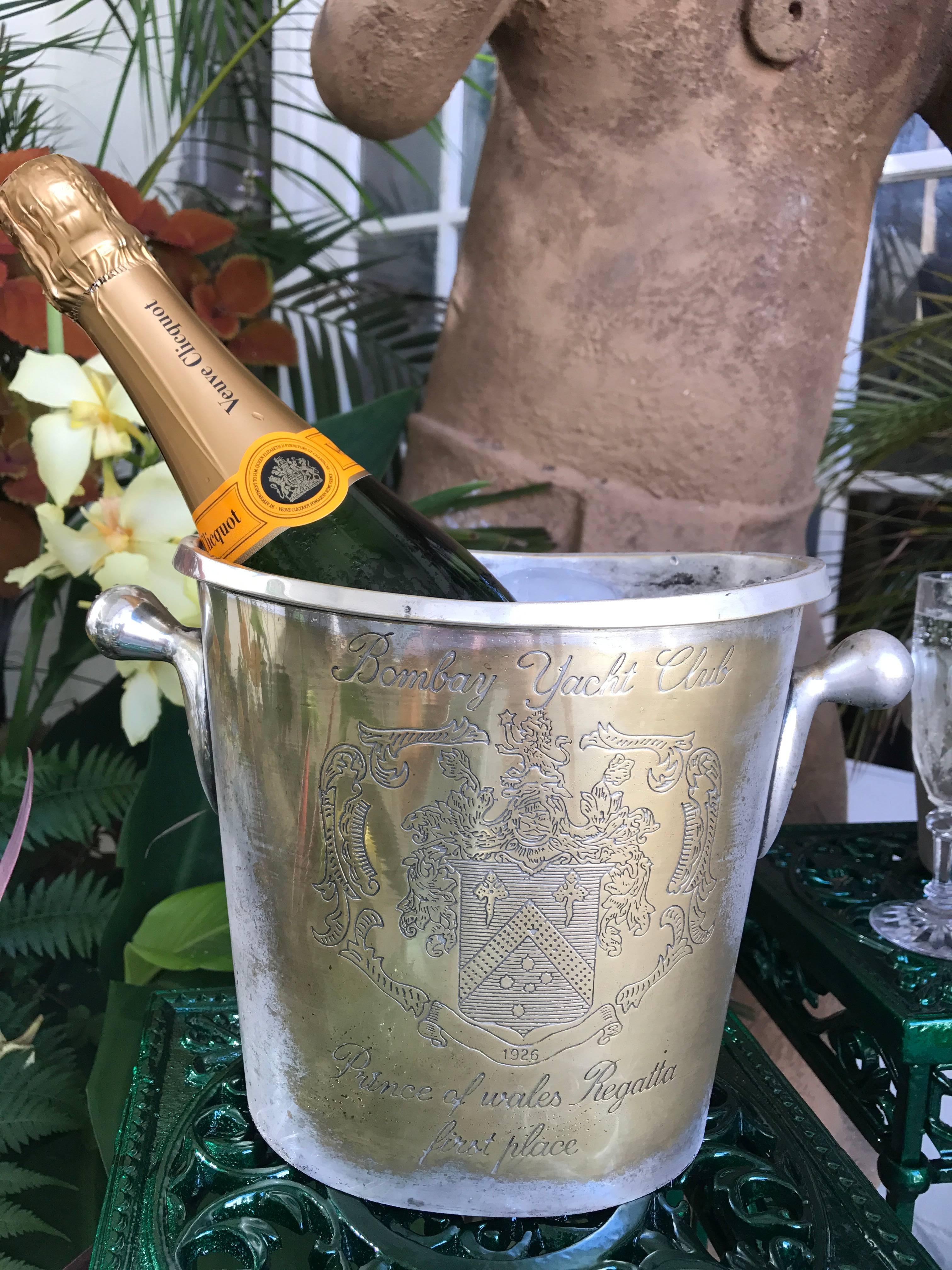 Silver plated champagne bucket from the Bombay yacht club. It was given as a first prize trophy for the Prince of Wales Regatta displaying an elaborate Armorial dated 1926. It is heavy in weight and of highest quality. The handles are pegged through
