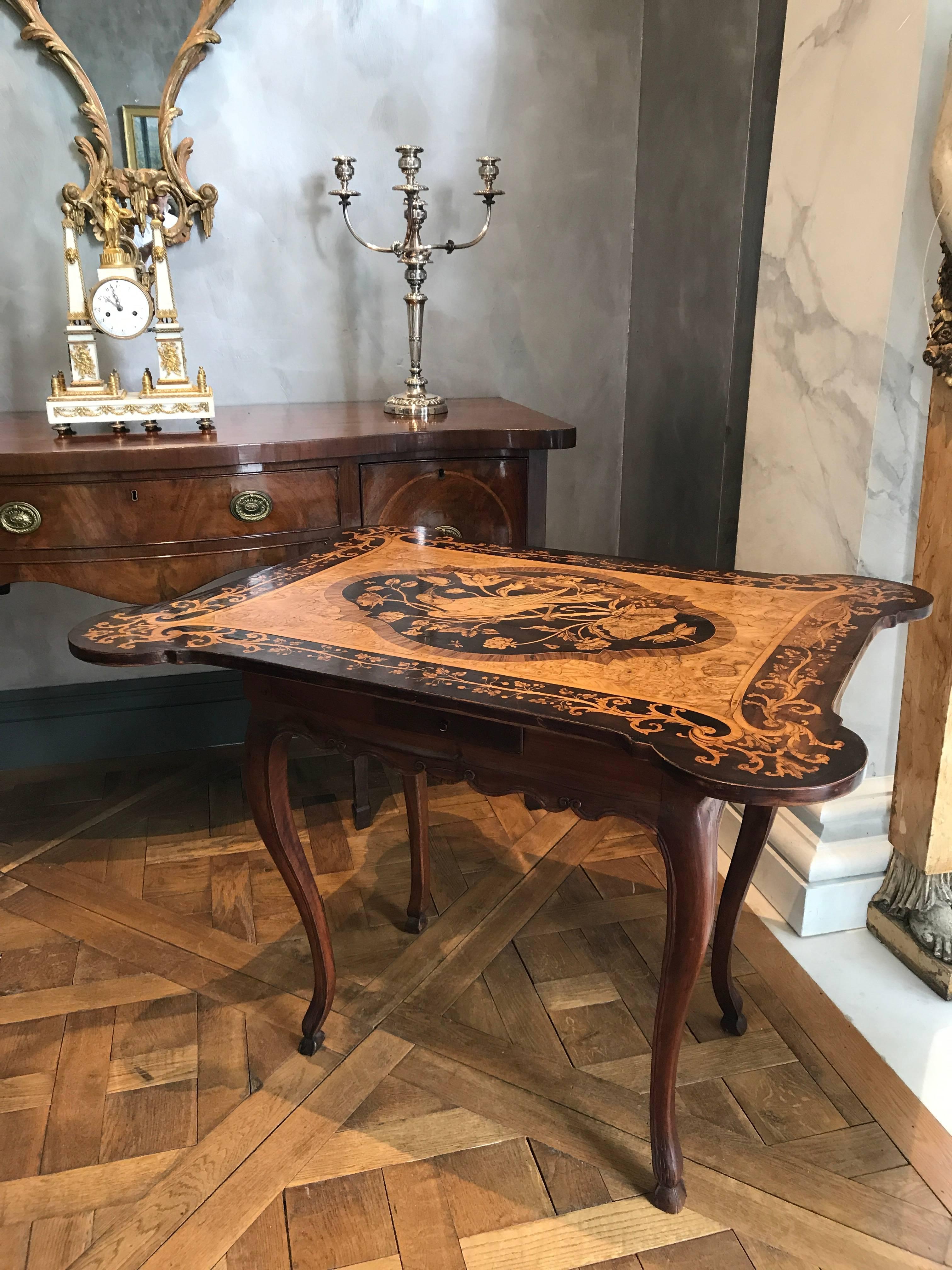 A breathtaking masterpiece in marquetry produced in the late 18th century in Holland. The top depicts a Heron surrounded by butterflies, dragonflies and flowers and is framed in a foliate motif. The woods used are olivewood, kingwood, tulipwood,