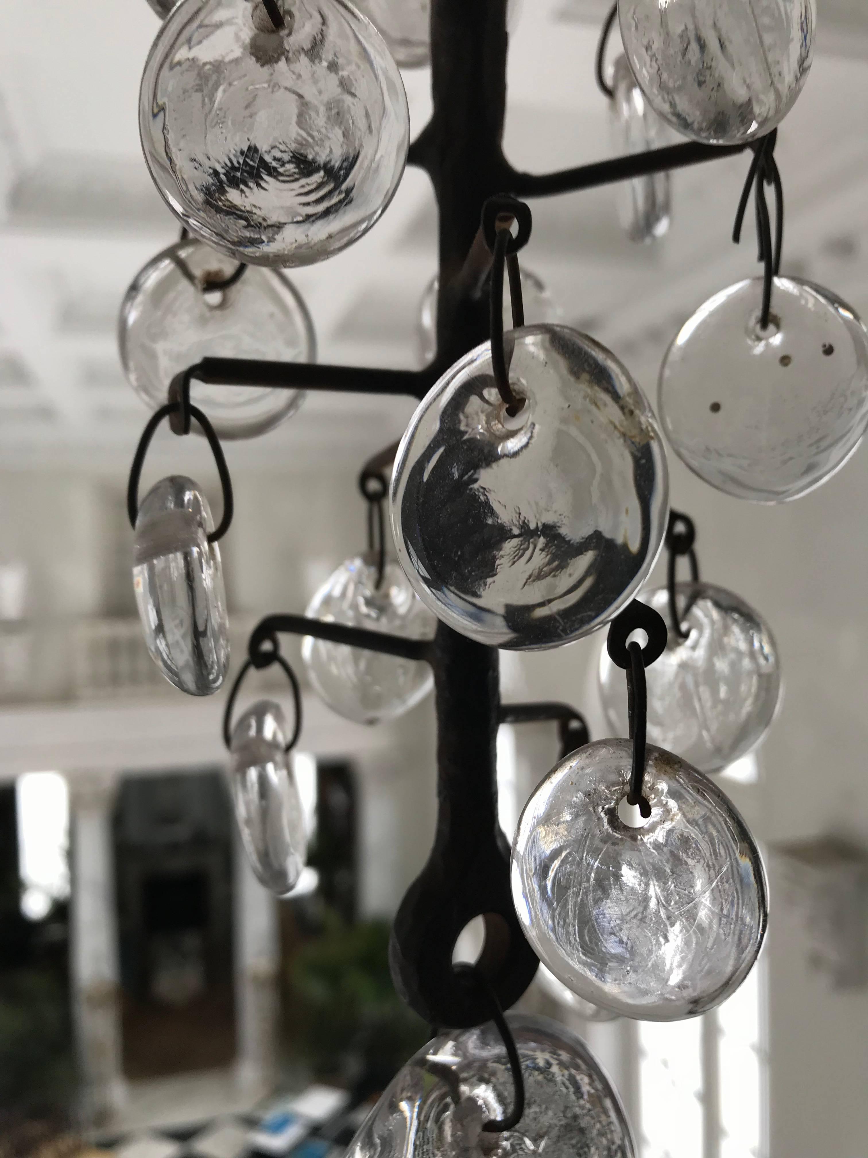 This Original Eric Hoglund (for Kosta Boda) 11-arm Chandelier was made of hand-wrought iron and circular, clear glass pendants of various sizes, some containing molded reliefs of fish and square faces.
Swedish,ca 1960.