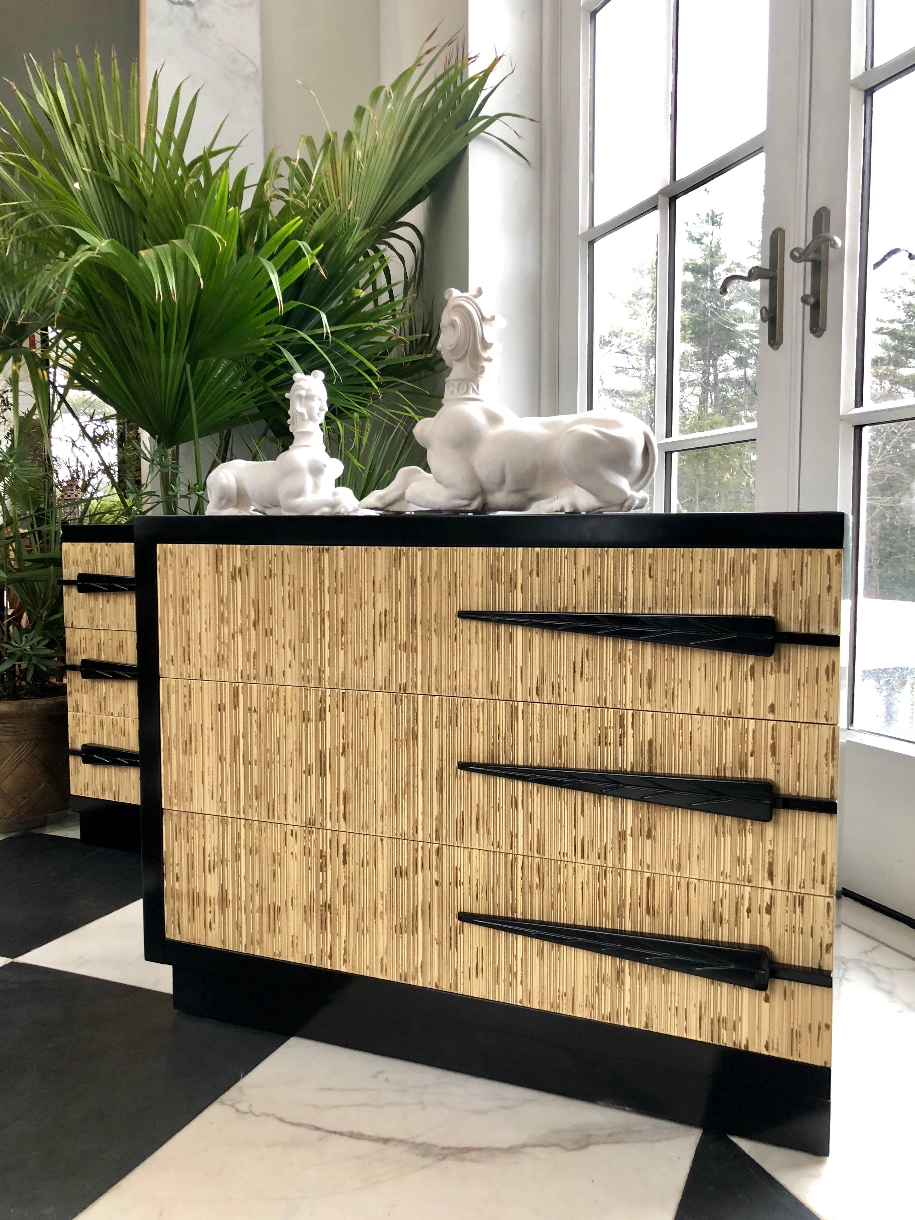 This wonderful pair of Mid Century Modern chest of drawers have a deeply textured fronts, painted in off-white and gold to resemble fine bamboo. The top and sides are lacquered in black and is new refinished. 