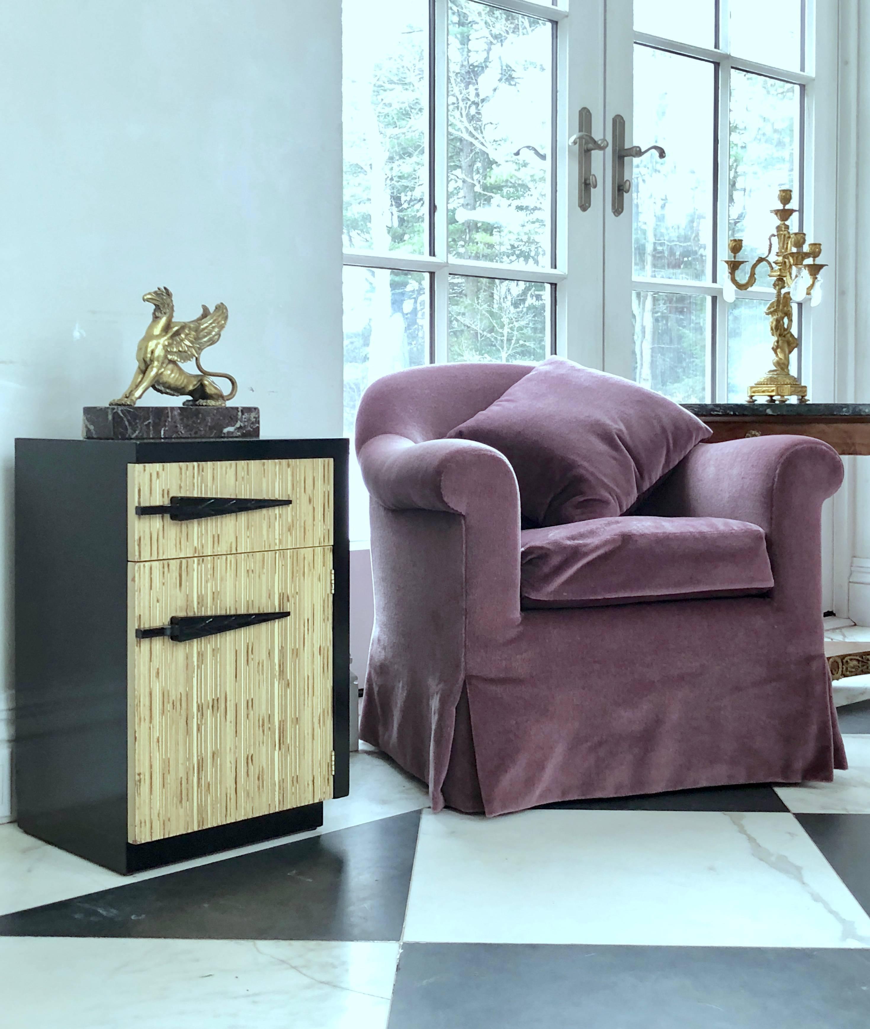 A most unusual pair of Mid-Century Modern bedside tables. The door panels have deep texture in the straight wood grain to resemble bamboo or grass.