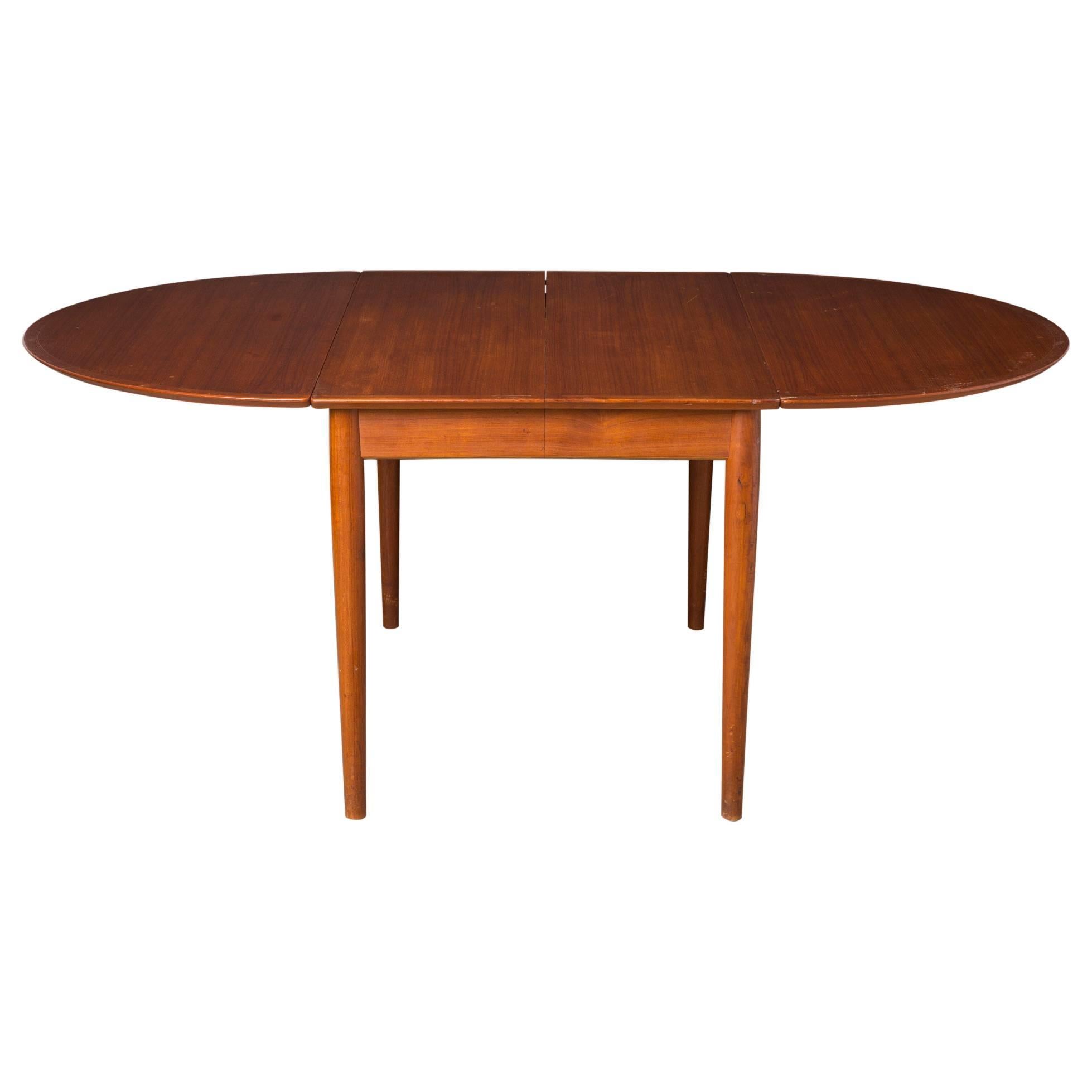 Authentic 1960s Arne Vodder design for Sibast. A Danish modern extendable dining or game table with rounded drop leaf sides. Perfect for a breakfast nook, and expands to accommodate large parties.  