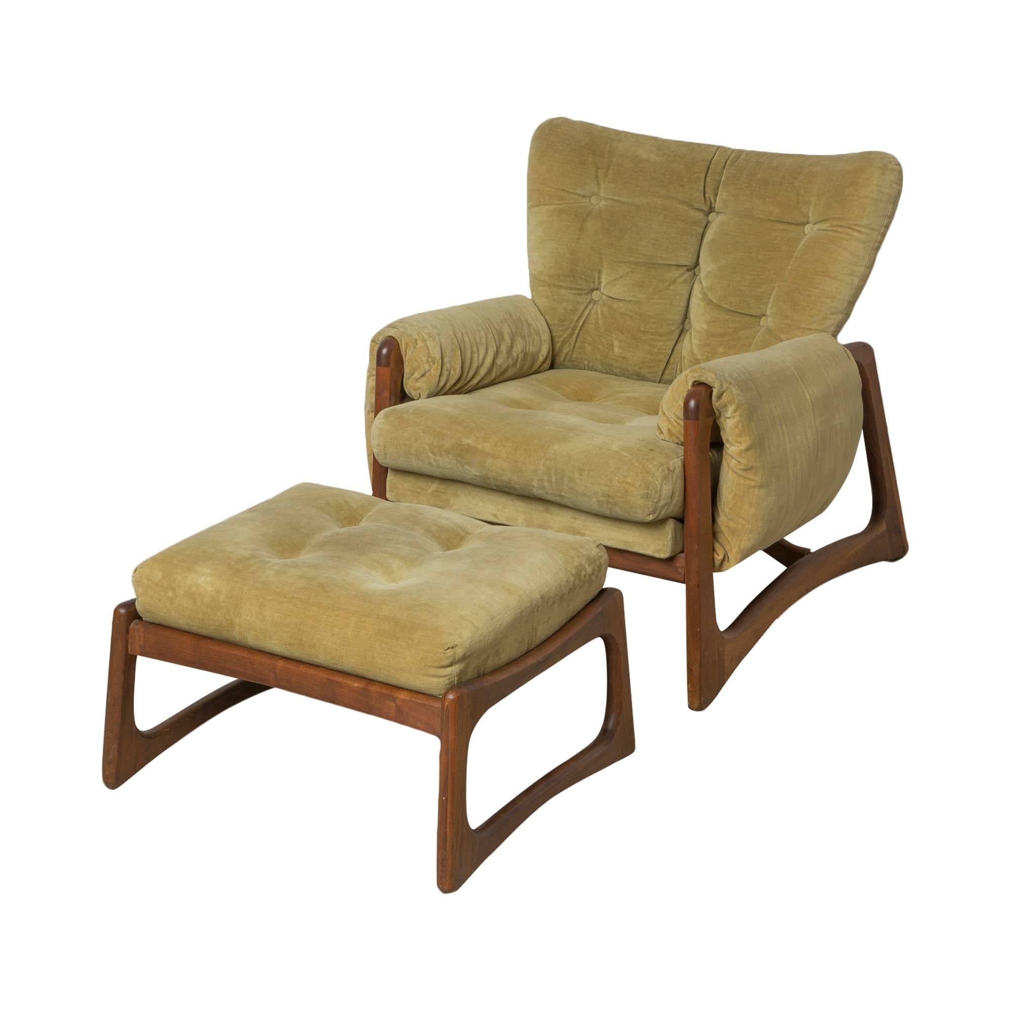Lounge chair and ottoman by Adrian Pearsall for Craft Associates. Upholstered in luxurious green vintage velvet with a beautiful walnut frame. This piece is unique to others you may find in a similar style in that it's accompanied by both an ottoman