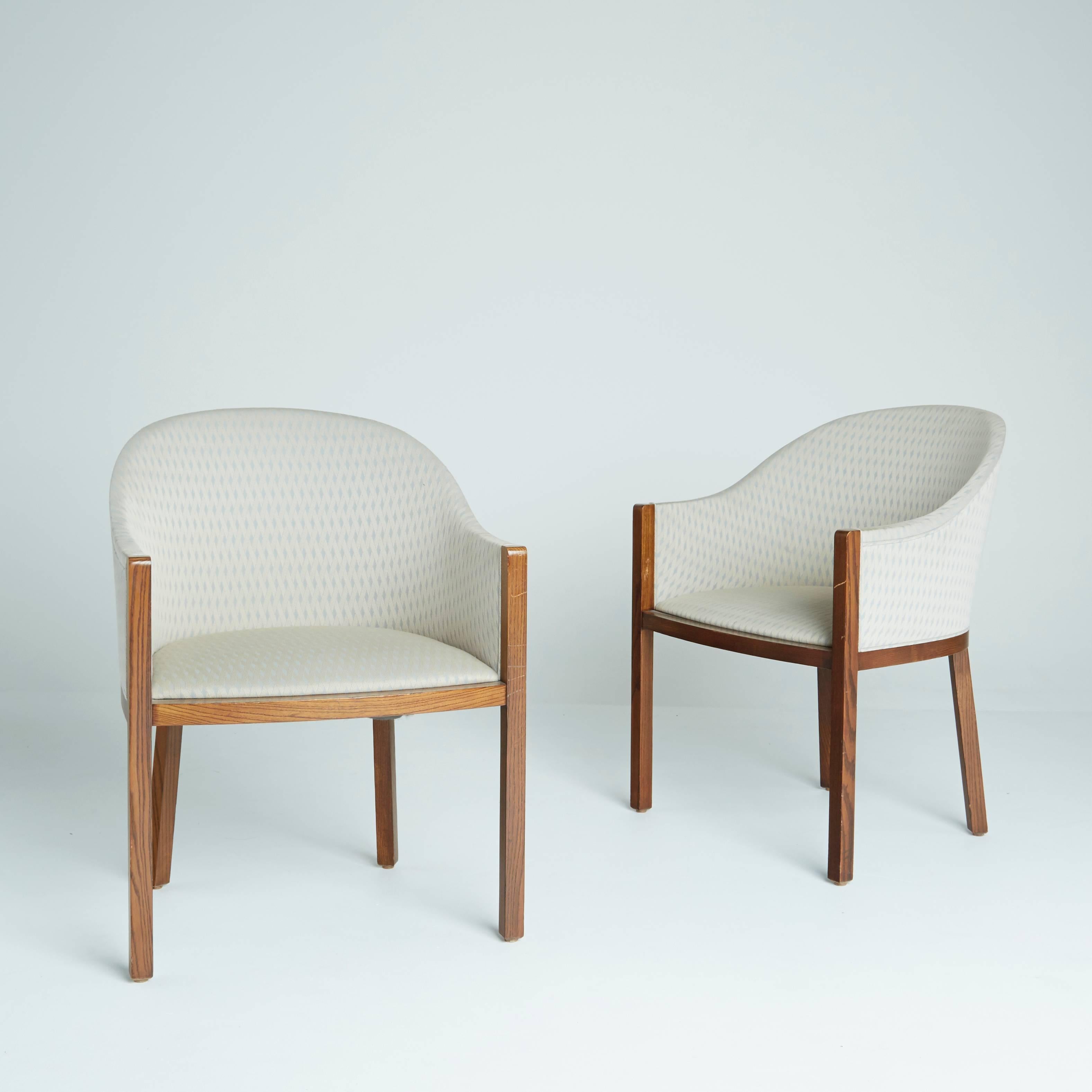 These sculptural lounge chairs by Ward Bennet for Brickel Associates feature Classic curvature from the back rests into the arms. The off-white and light blue upholstery has a delicate pattern and a slight sheen, an elegant contrast to the rich