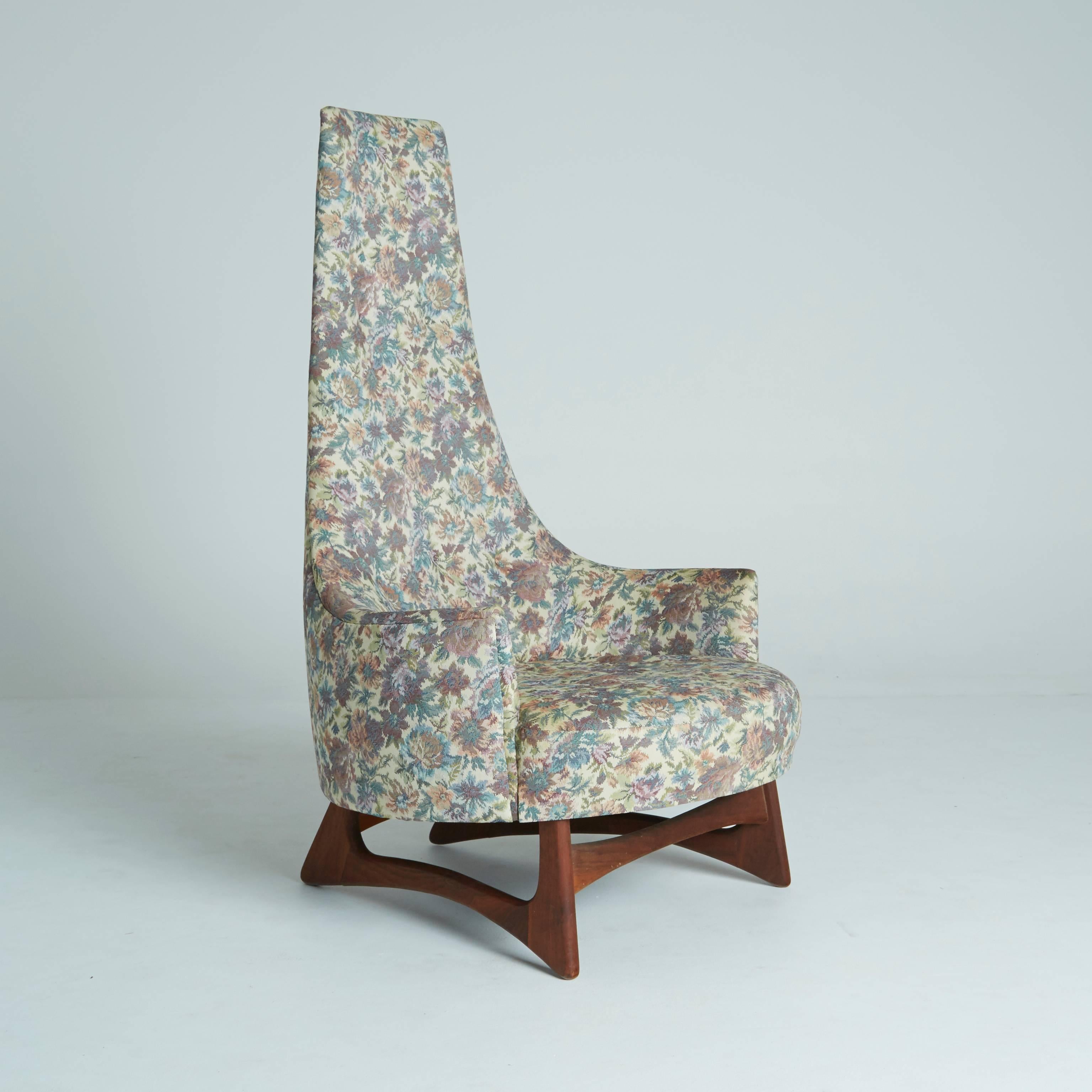 This Adrian Pearsall high back lounge-chair or armchair is a regal Mid-Century Modern Classic.

The biomorphic curvature of the sculpted walnut legs beautifully offsets the funky, floral pattern. Consider this for a reading chair, corner chair, a