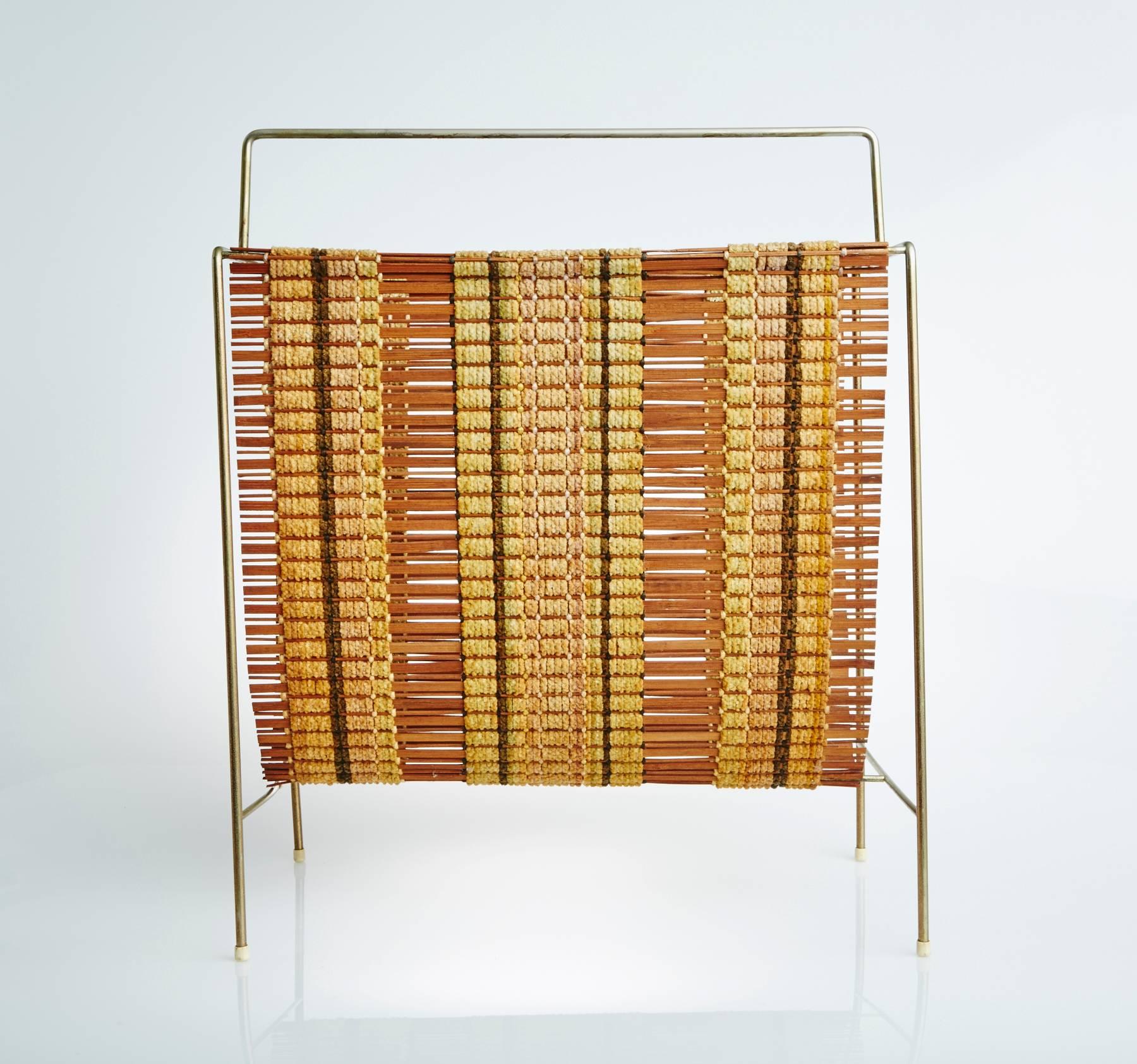 This Maria Kipp woven magazine rack is a very rarely seen item and quite the find for the Mid-Century Modern enthusiast or collector.  And a great finishing touch for any designer.  

One of the most accomplished designers of handwoven textiles from