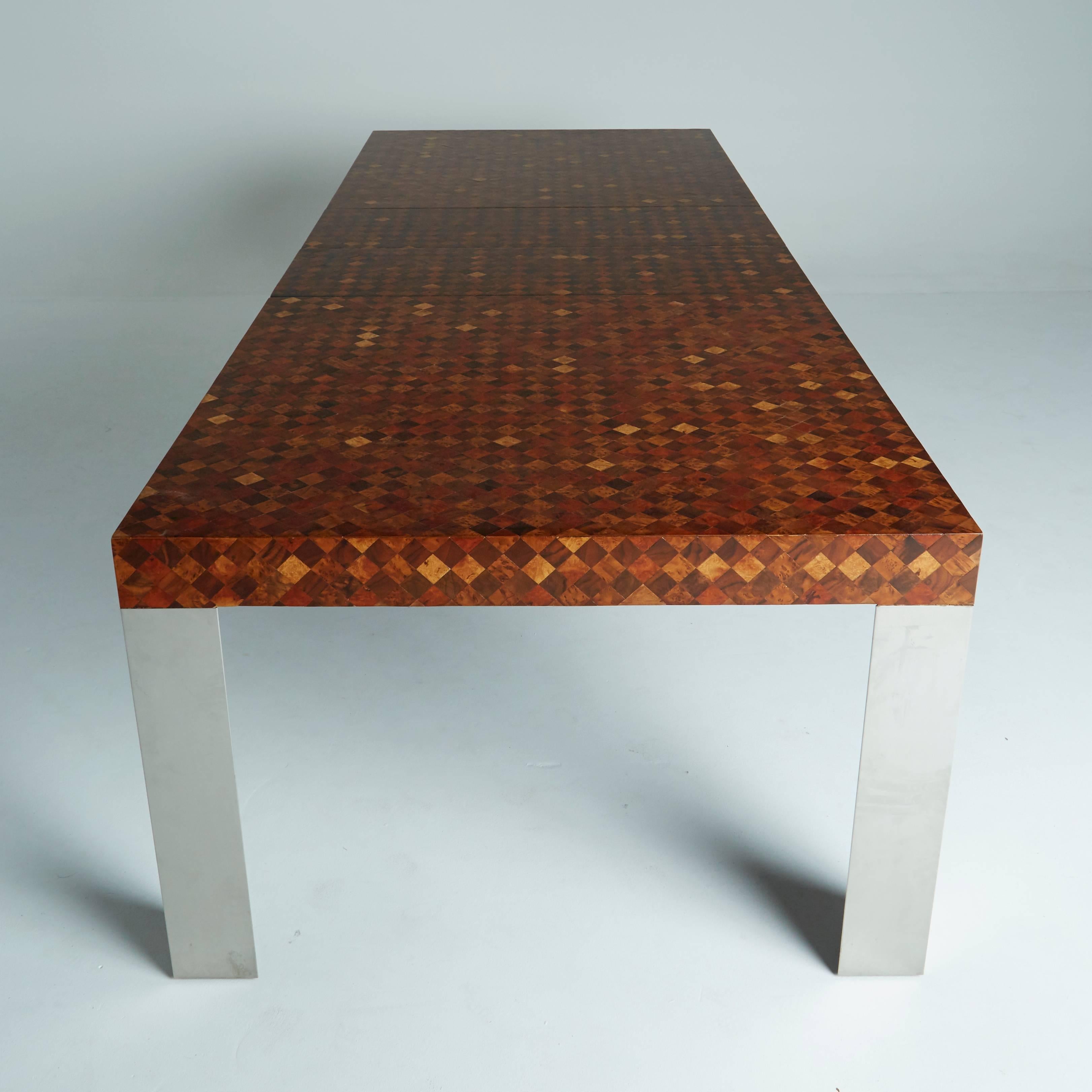 Designed, circa 1970 by Paul Evans for Directional, this distinct table is a remarkable and rare find. An alluring, patchwork tabletop with a checkered collage of exotic woods sits on top of four triangular chrome legs. Two 15