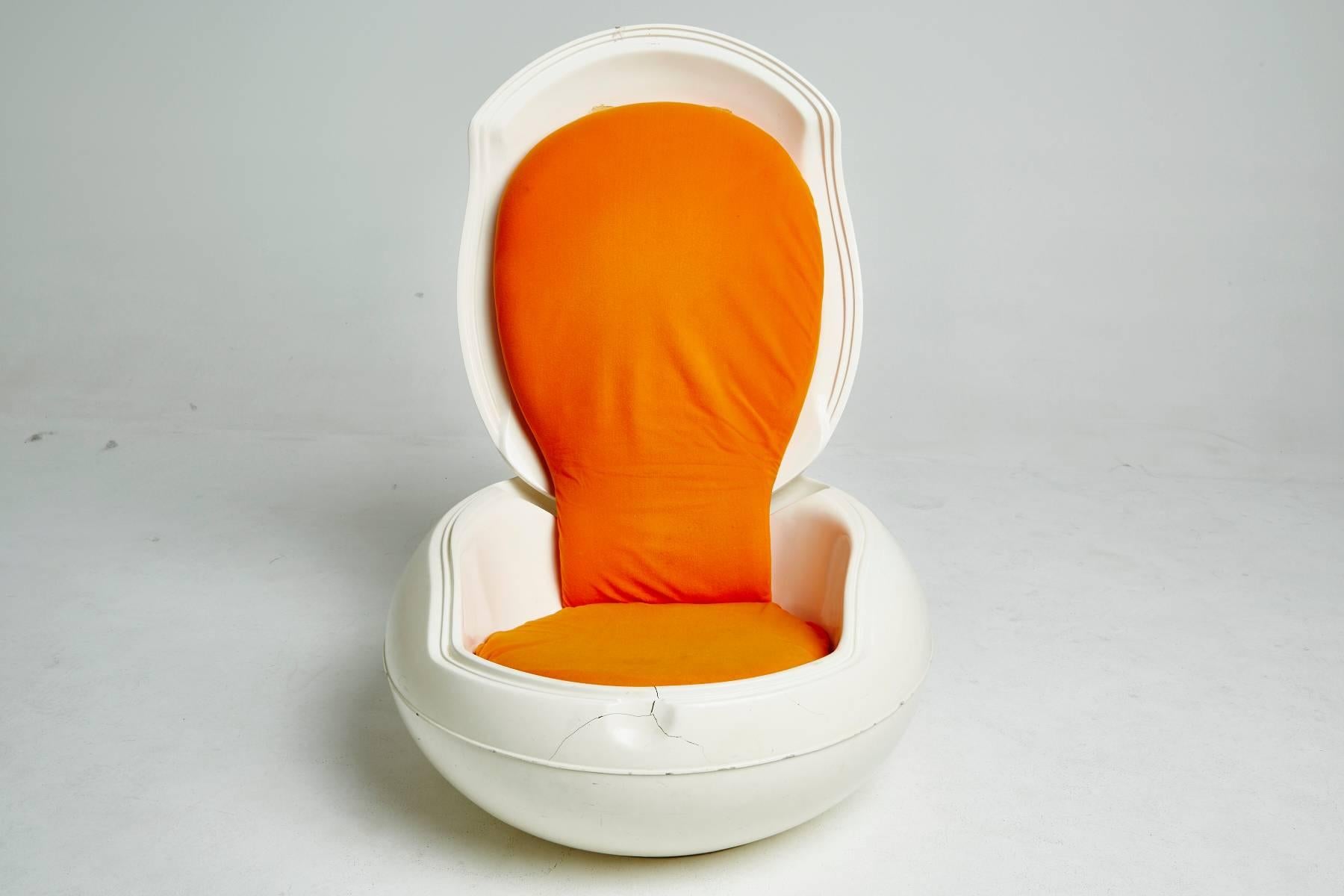 This iconic garden Egg chair was created by Hungarian designer Peter Ghyczy in 1968 for Rheuter products. When closed, the white polyurethane shell is a clean, round, egg-shaped dollop. Lift the lid to reveal a hidden low lounge chair with a tall