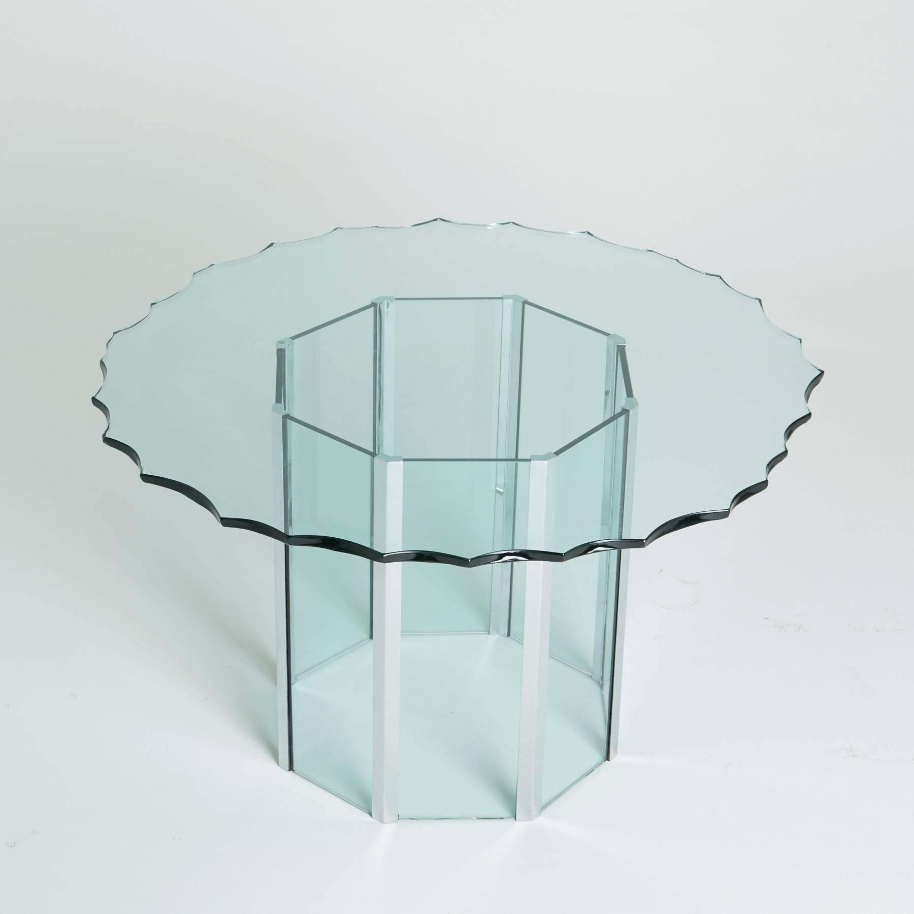 This unusual piece was a custom order created circa 1970 by Pace. The round, green glass was customized with stylistic divots along the edges of the round tabletop. Panels of green glass alternate around octagonal chrome frame of the base. Dining