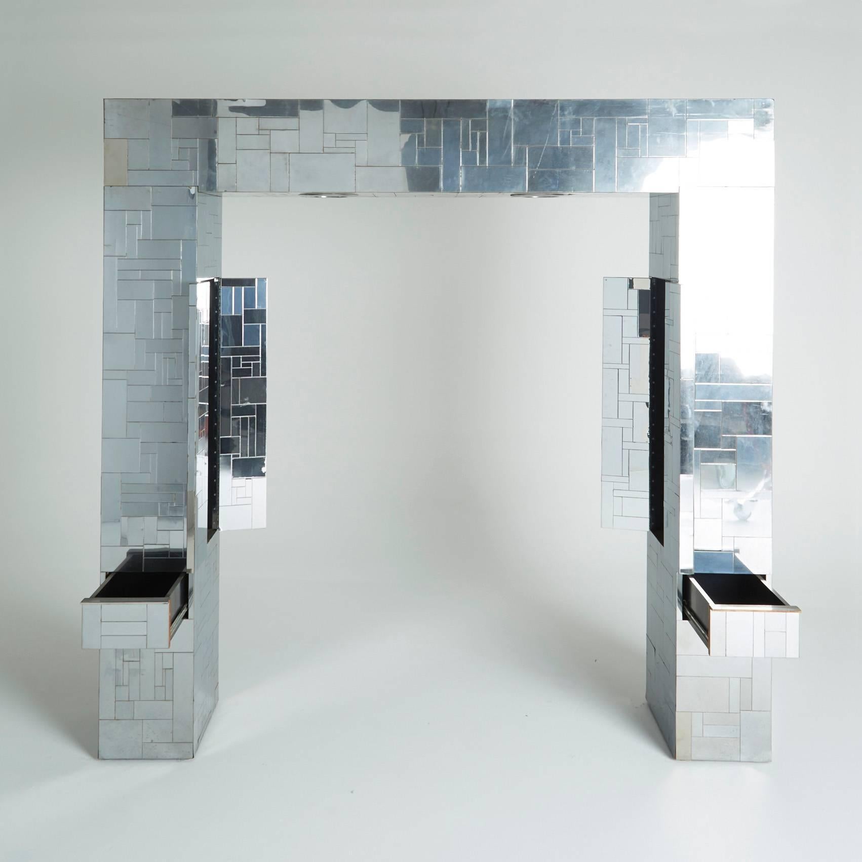 From the stunning Cityscape collection by Paul Evans circa 1970, this remarkable headboard is fit for a queen size bed. Each pillar of the reflective metal patchwork archway possesses a two-door cabinet on the interior wall and a pull out drawer
