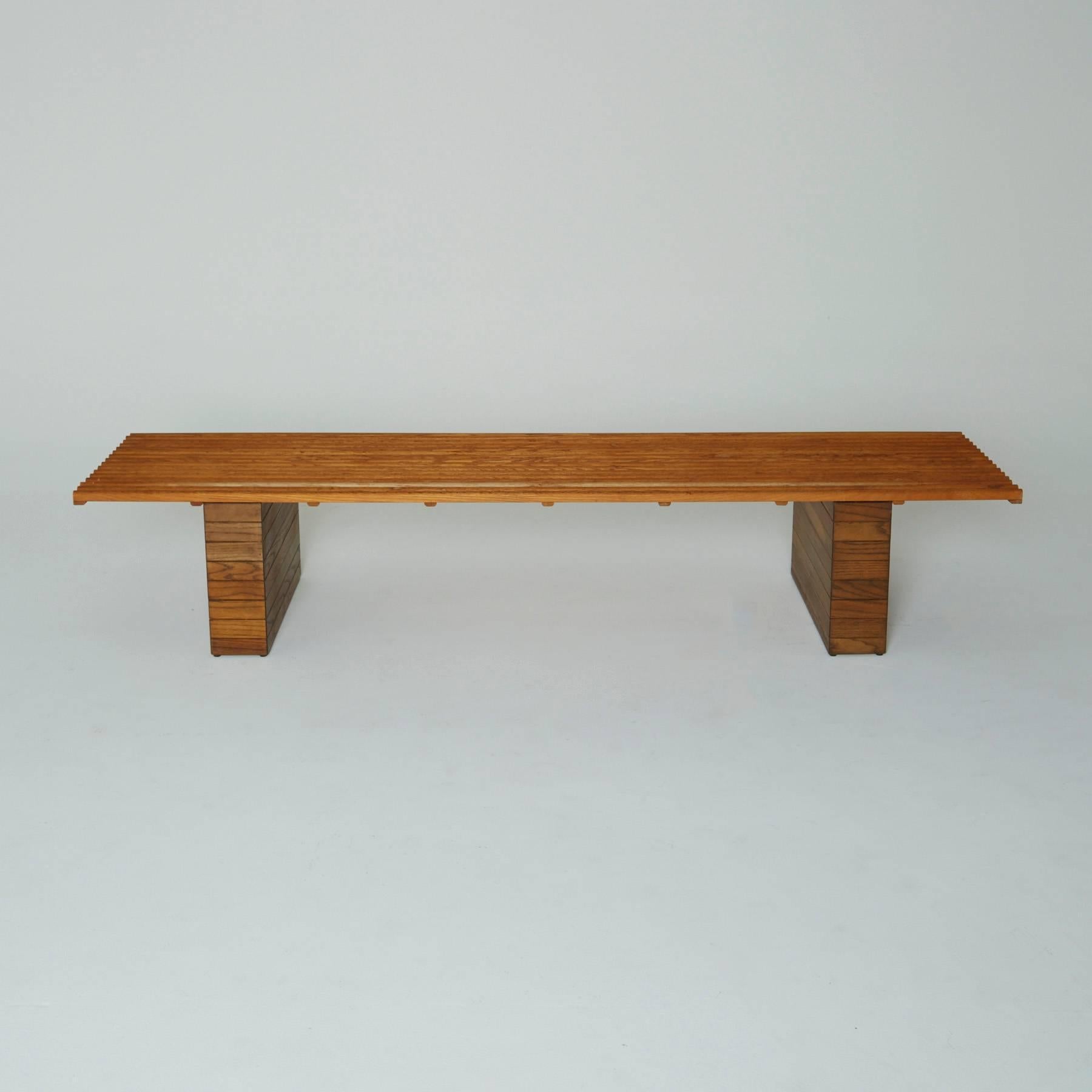 The slatted oak seat is elevated on two wide, stacked legs, produced by Forms and Surfaces. The design is attributed to Evelyn and Jerome Ackerman.

The Ackerman pair is one of most recognized Mid-Century design teams of textiles, ceramics, and