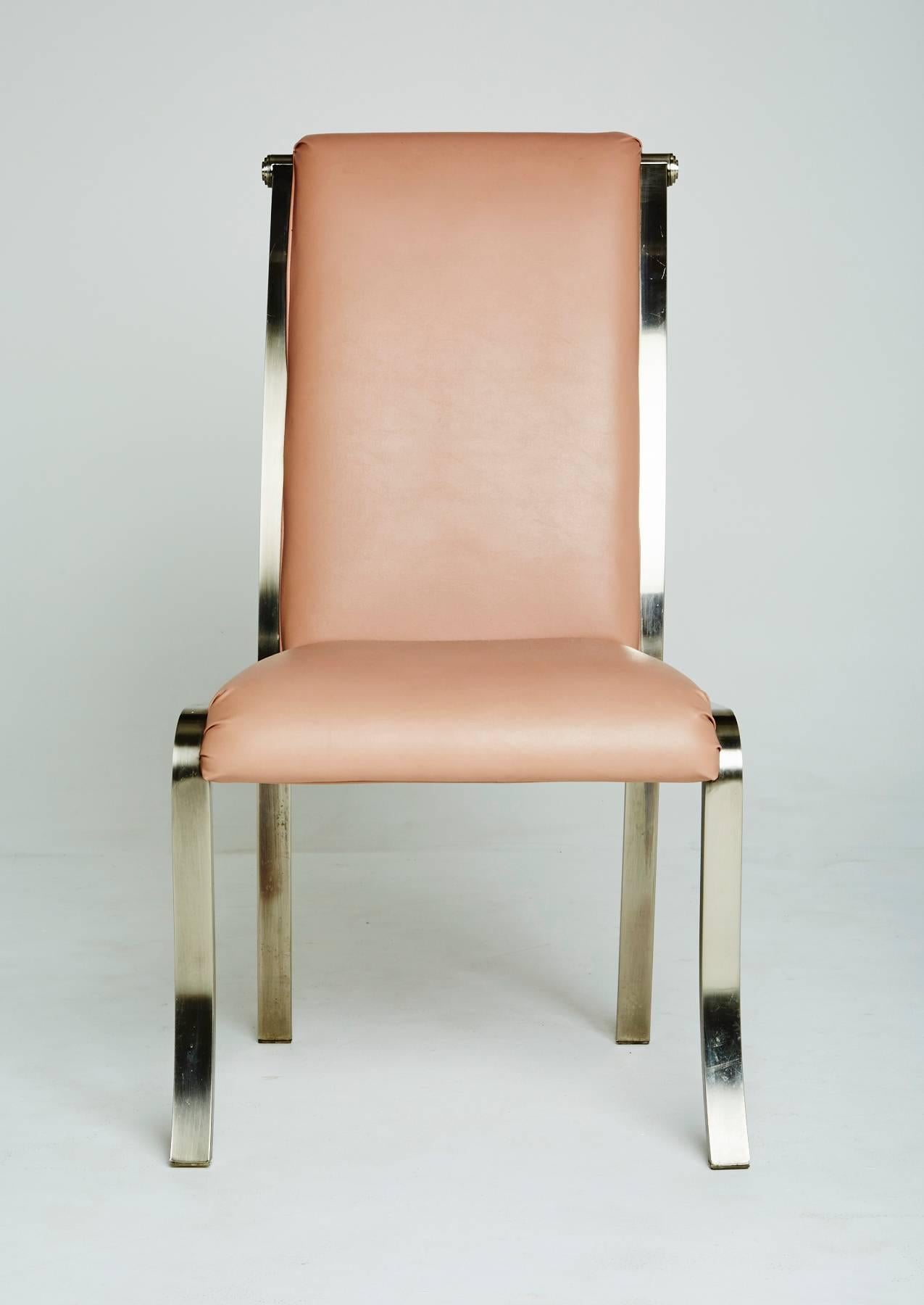 Created by the Design Institute of America, this set of dining chairs consists of two armchairs and four side chairs, all chairs are marked with DIA labels underneath the original upholstery. 

Each chrome frame has a slight, elegant curve to its