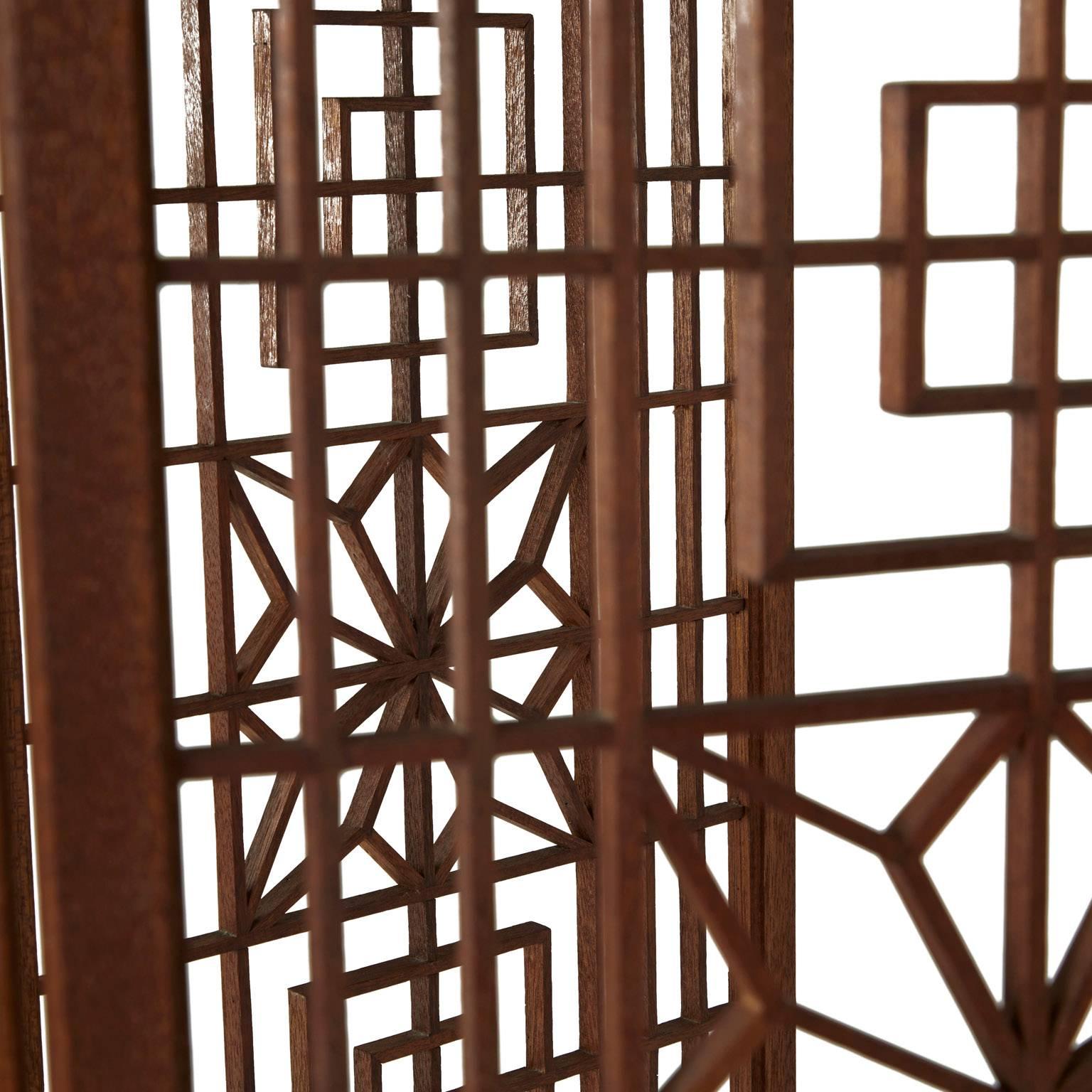 Illustrative of the 1960s design movement, this elegant Moroccan inspired room divider fabricated from teak incorporates both latticed and woven pieces.

The central detailed latticed portion is made up of small wood pieces precisely cut to