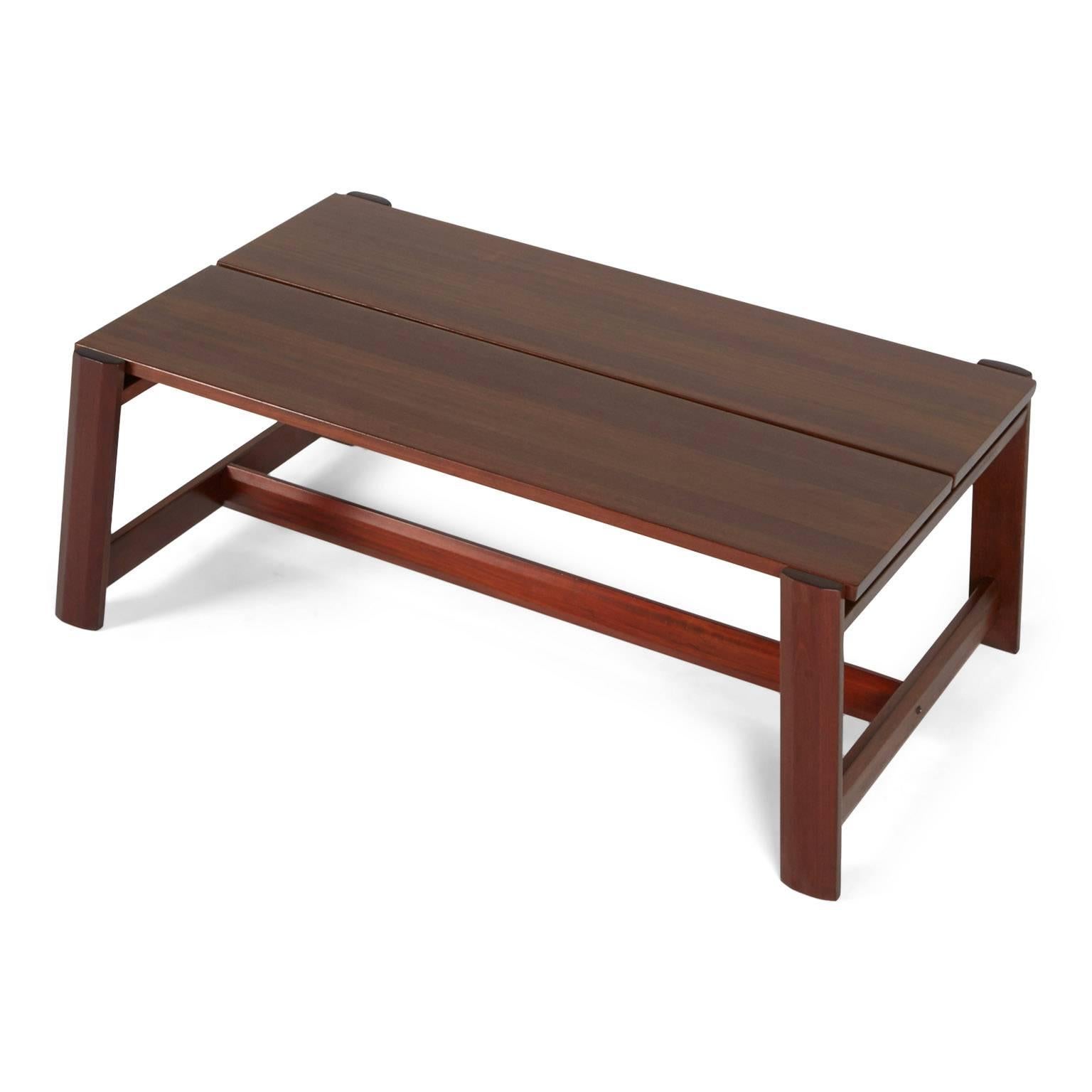 Designed by Sergio Rodrigues for Oca Brazil, this rich, expansive mahogany table would be a solid addition to your living room. The versatile finish is suited to complement a range of decor styles such as Brazilian modern, contemporary, mission and