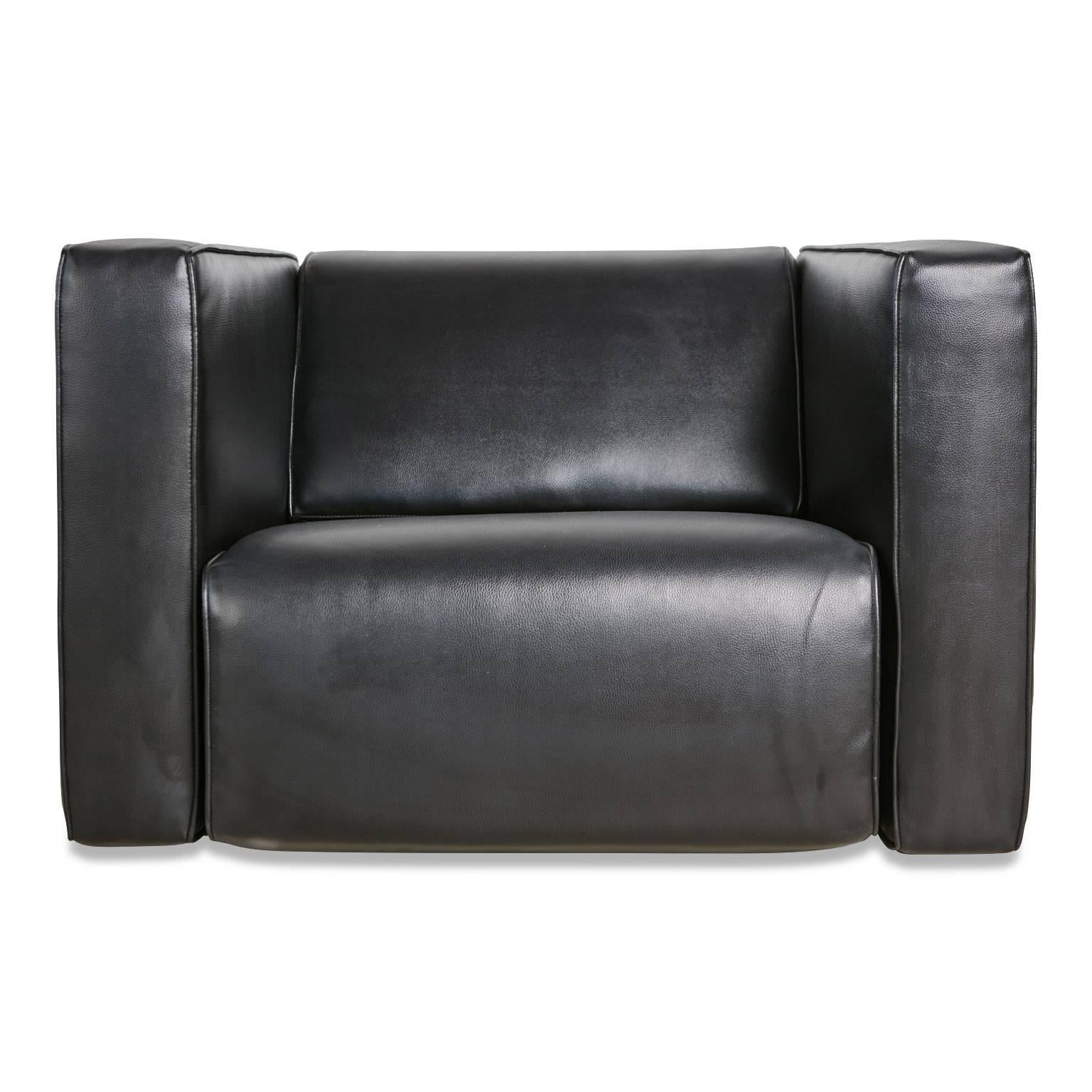 Substantial, deep seated, cube shaped Brazilian club chairs with black leather upholstery and polished chrome band detail. Similar in style to Le Corbusier's LC2 lounge chairs for Cassina, these extremely comfortable chairs are the epitome of cool.