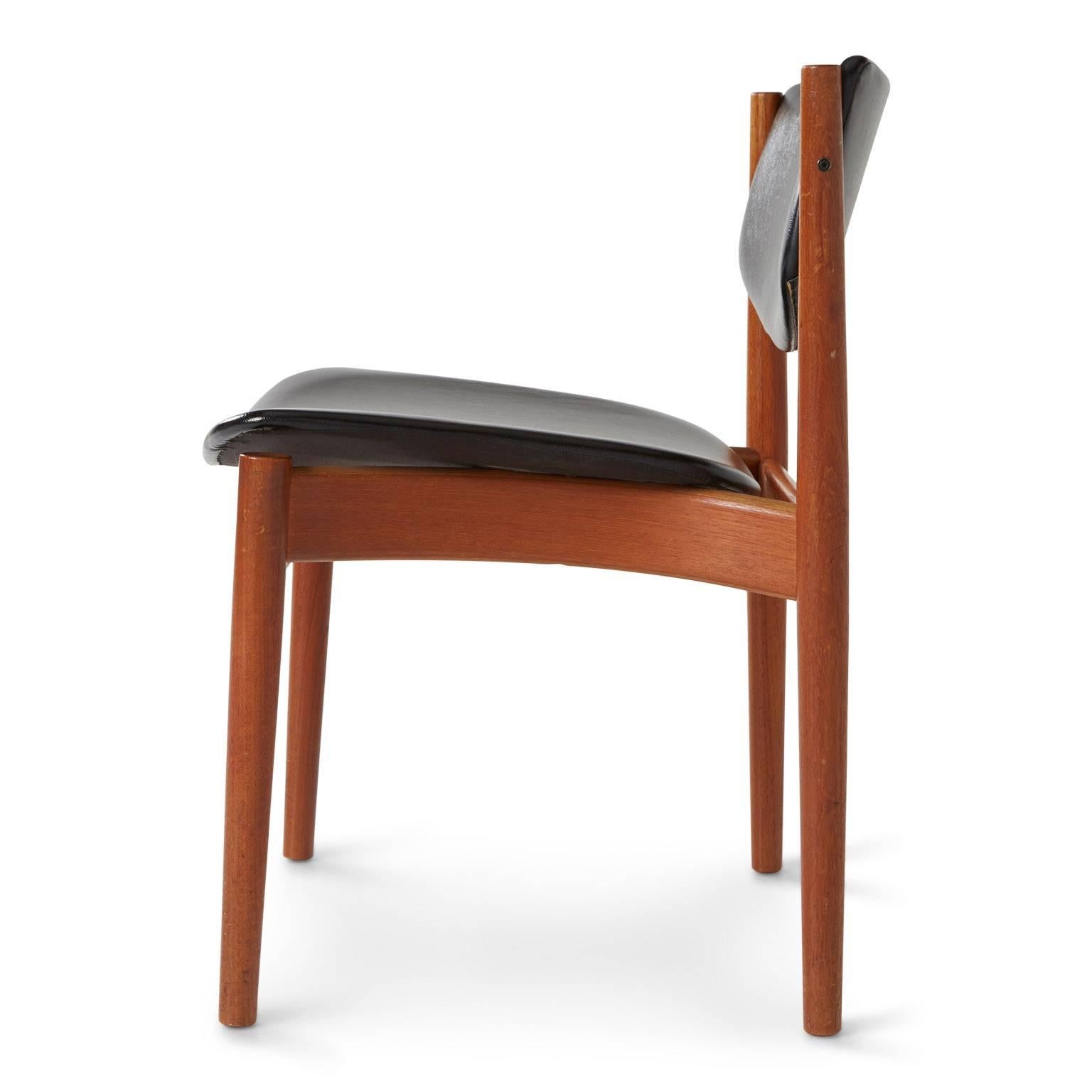 Designed by Finn Juhl for France & Son and imported by John Stuart, a New York designer showroom, this elegant chair was made in Denmark and bares the manufacture stamp of origin underneath. It maintains original black vinyl upholstery that is