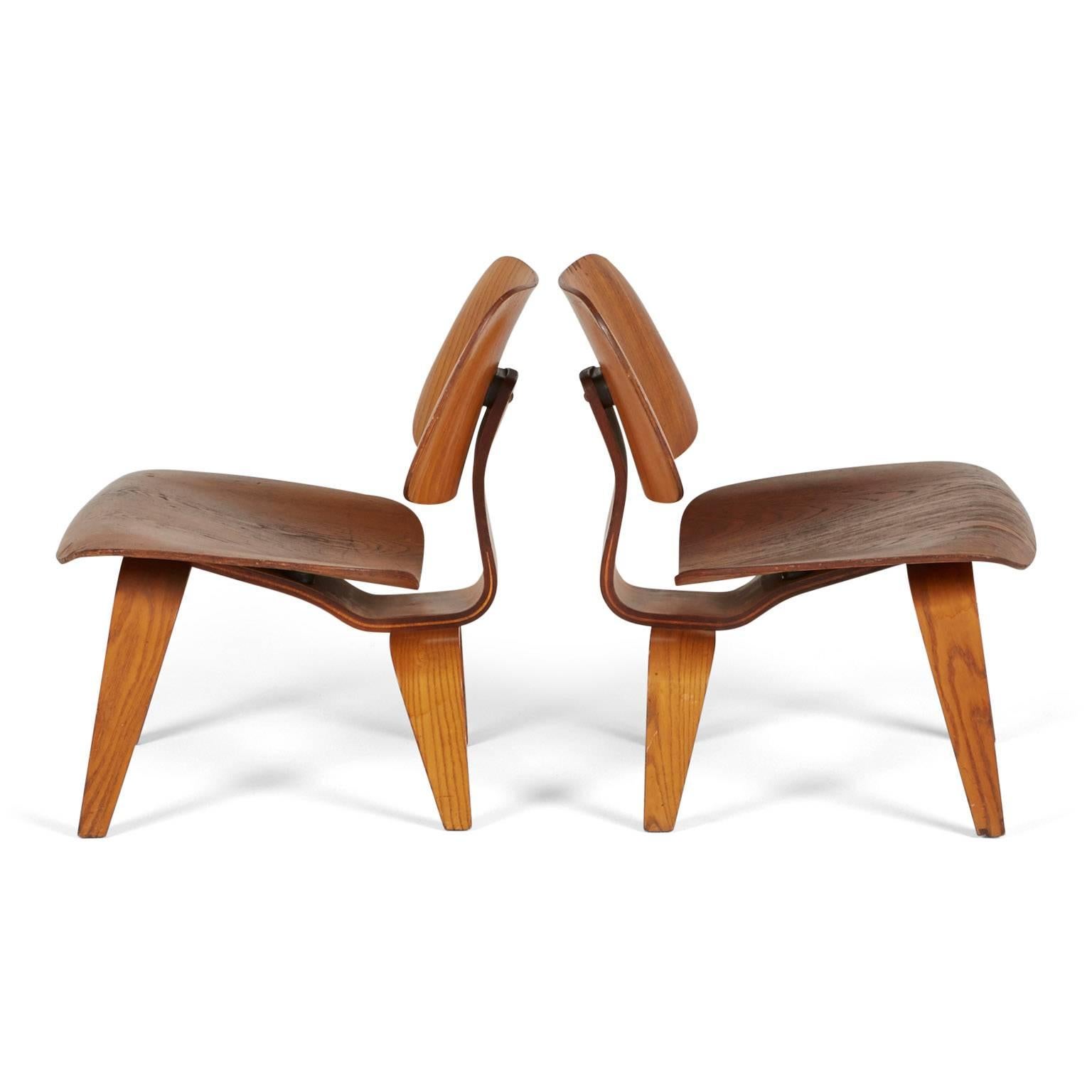 In 1946, these world-renowned LCW or “Lounge chair wood” chairs, by Charles and Ray Eames for Herman Miller, were lauded by Time magazine as the best design of the 20th century. 

These two (2) early production chairs are comprised of low-slung,