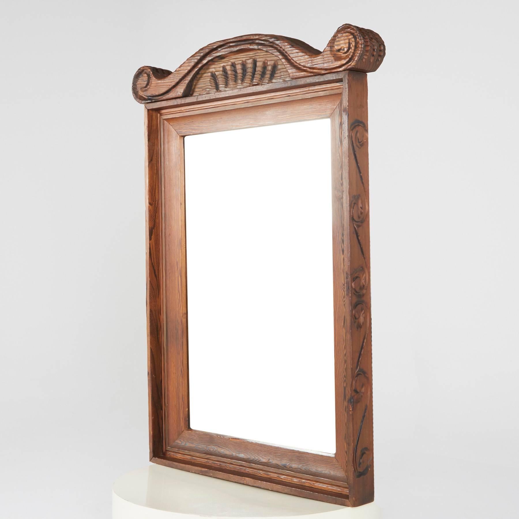 This ornately crafted large-scale red walnut mirror with carved exotic details is a testament to William Westenhaver's Modern Primitive creations. Influenced by Polynesian natives sculpting their ancestral deities in to wood furnishings, Westenhaver