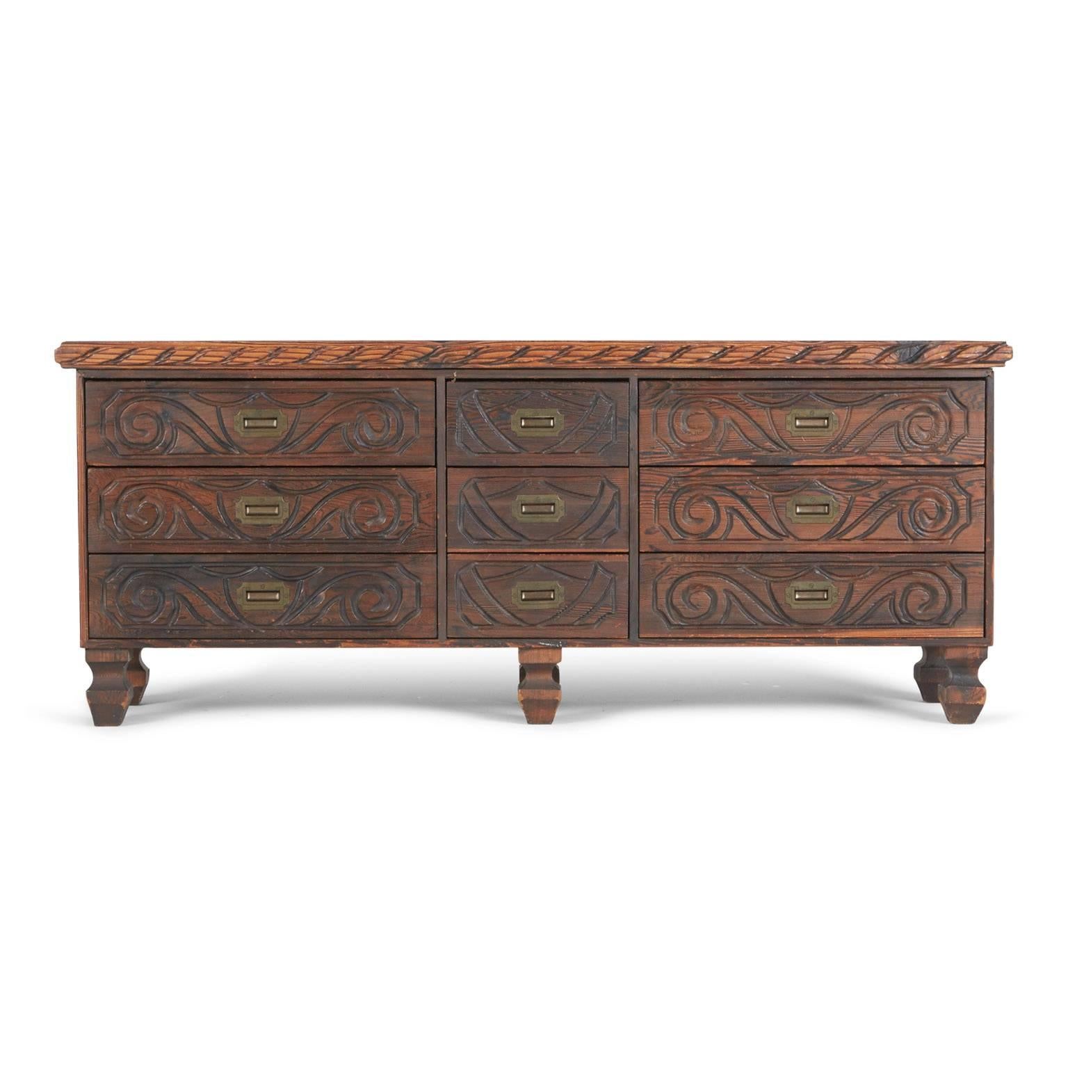 This ornately crafted red walnut dresser with carved exotic details is a testament to William Westenhaver's Modern Primitive creations. Influenced by Polynesian natives sculpting their ancestral deities in to wood furnishings, Westenhaver fused his