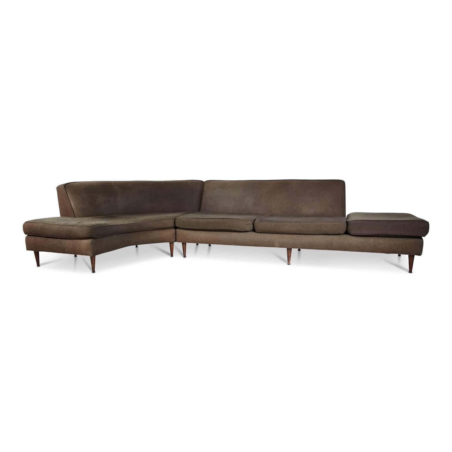 Gracefully curved sectional attributed to Harvey Probber, illustrated by the designer's innovative modern style and use of understated contemporary lines. Paralleled in this sofa is his application of flexibility of function and use of independent