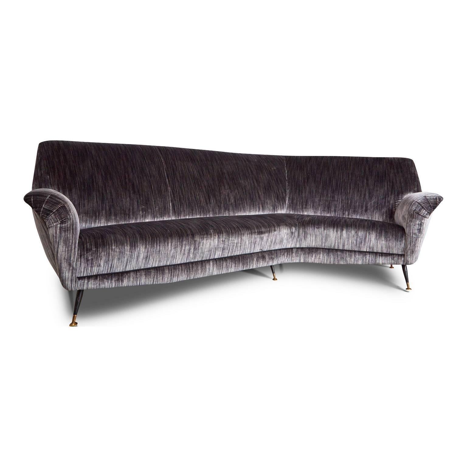 An elegantly silhouetted 1950s Italian curved sofa by Gigi Radice. Newly upholstered in a plush silk blend strie velvet, which changes its appearance with the light. The glossy sheen of the material can look almost silvery white or it can become a