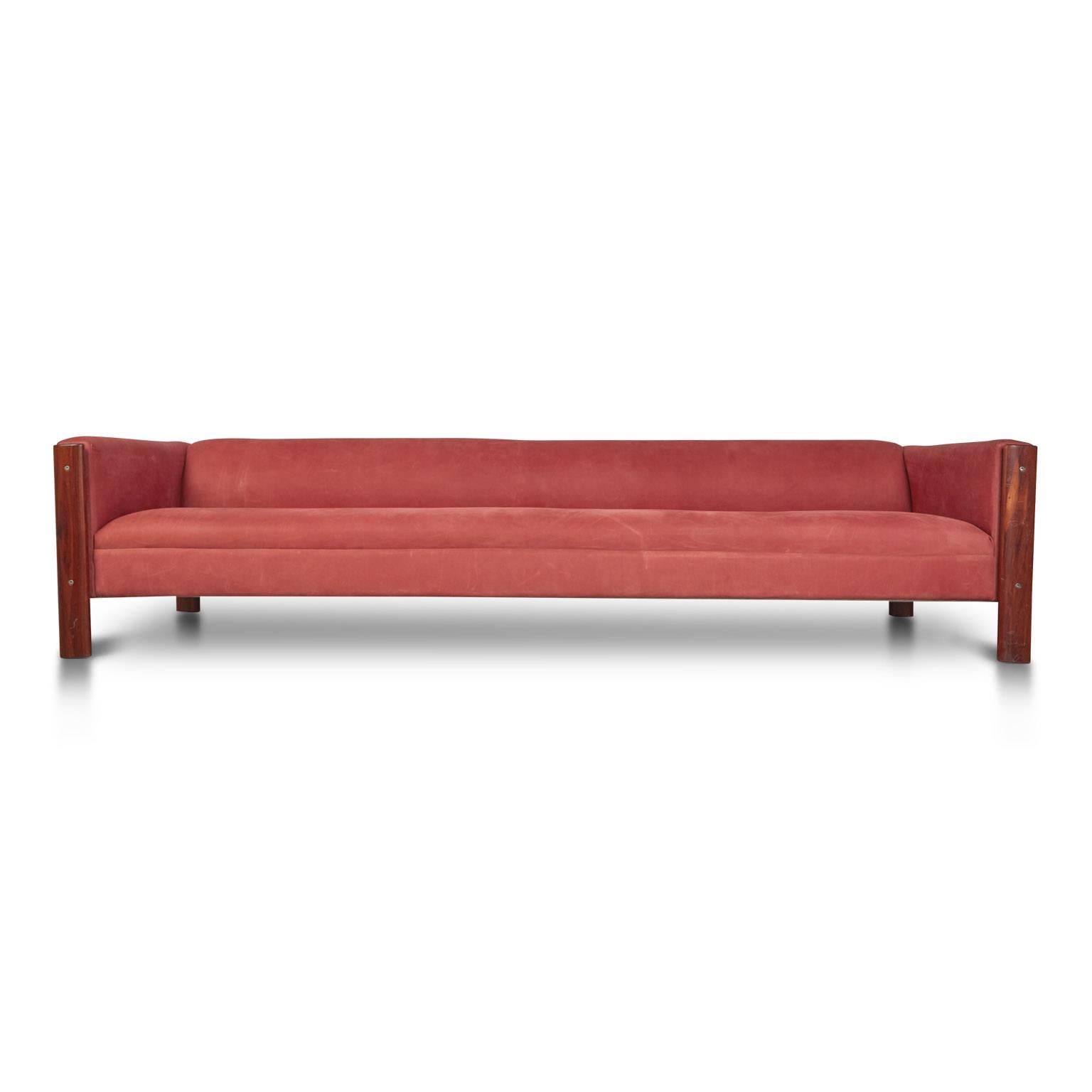 This bold 1960s sofa from Brazil features attention grabbing red suede upholstery and a low-set, ample seated design with rosewood frame details.

The simple, clean lines will fit right in to a range of interior styles, such as; a Contemporary loft,