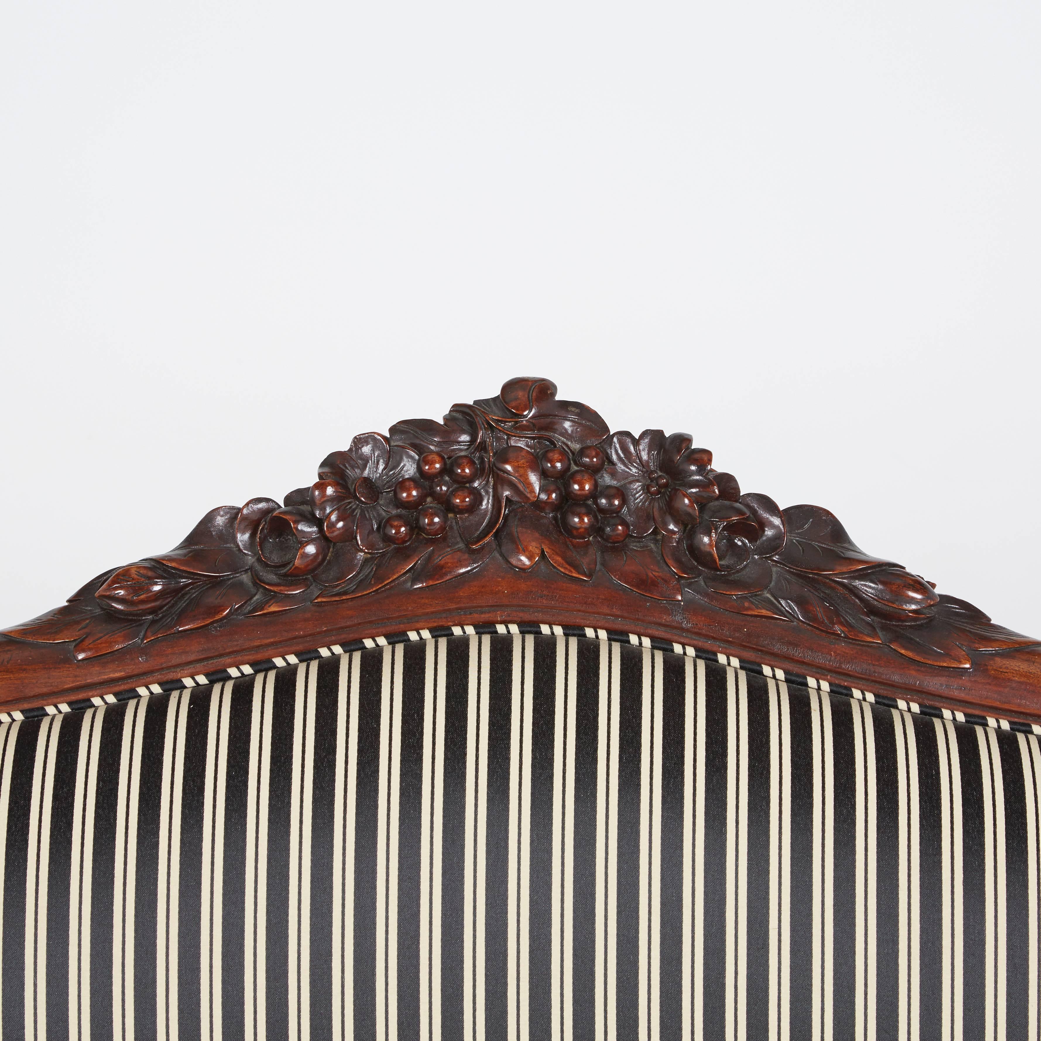 Late 19th Century Victorian Rococo Revival Sofa, Carved Walnut with Striped Upholstery, circa 1880