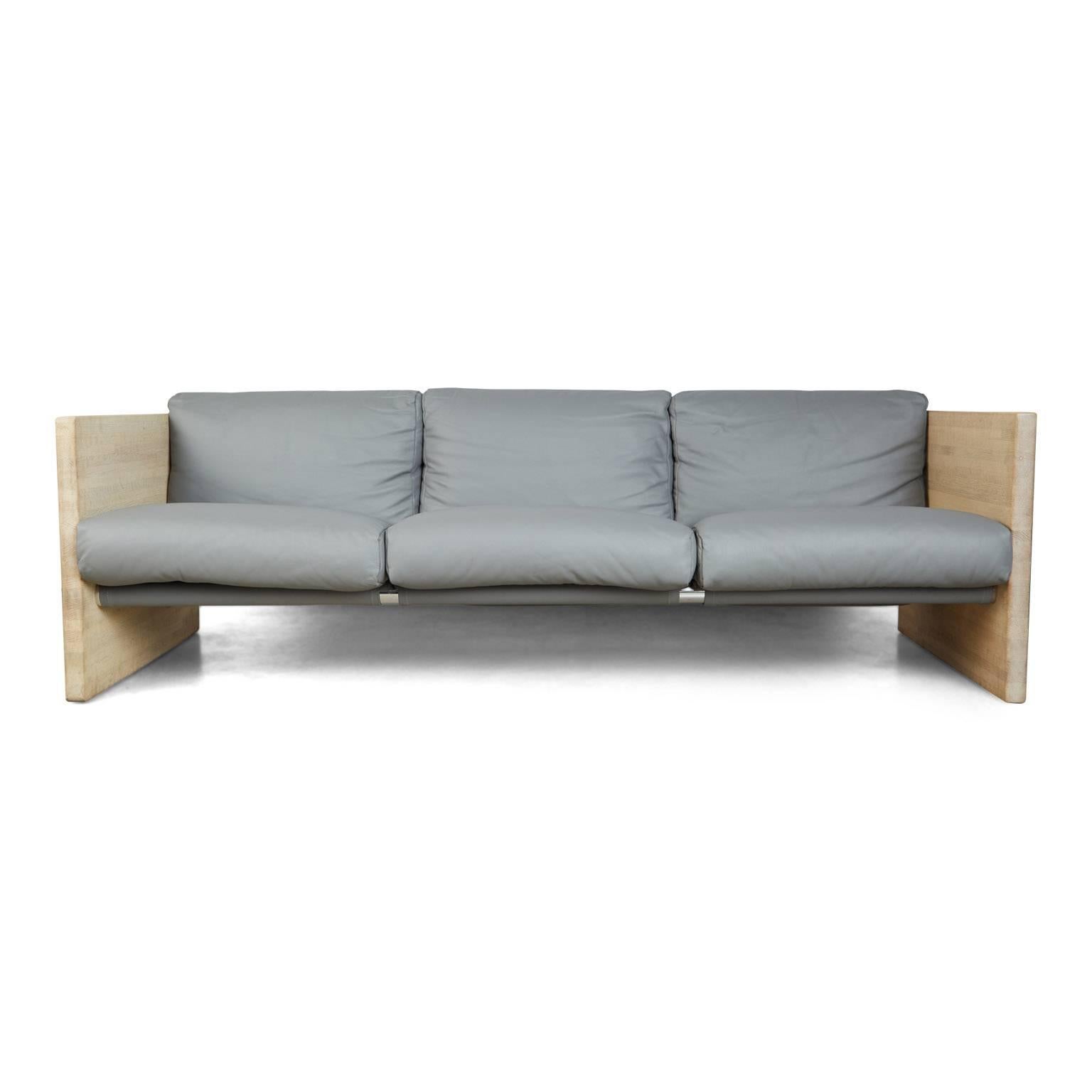 Handsome, recently restored Milo Baughman styled case sofa, newly upholstered using gorgeous on-trend light gray leather. Featuring angular cube shaped end panels, creating a strong, square Silhouette when this piece is viewed in profile. 

The