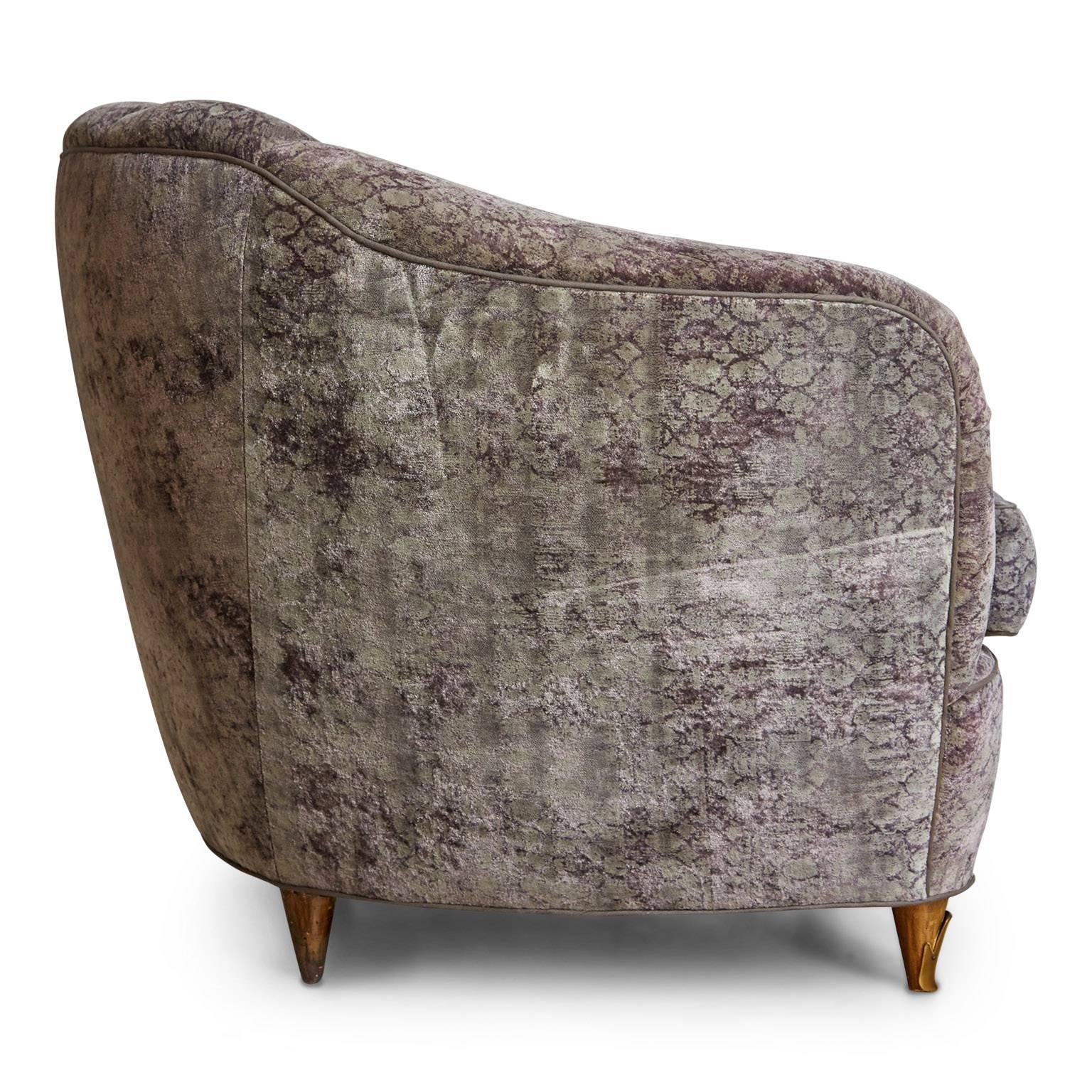 Highly detailed exquisite French Art Deco club chair that has been newly restored and reupholstered in a plush purple and grey silk velvet with subtle variations and use of pattern throughout. This gorgeous piece features a curved, ample padded
