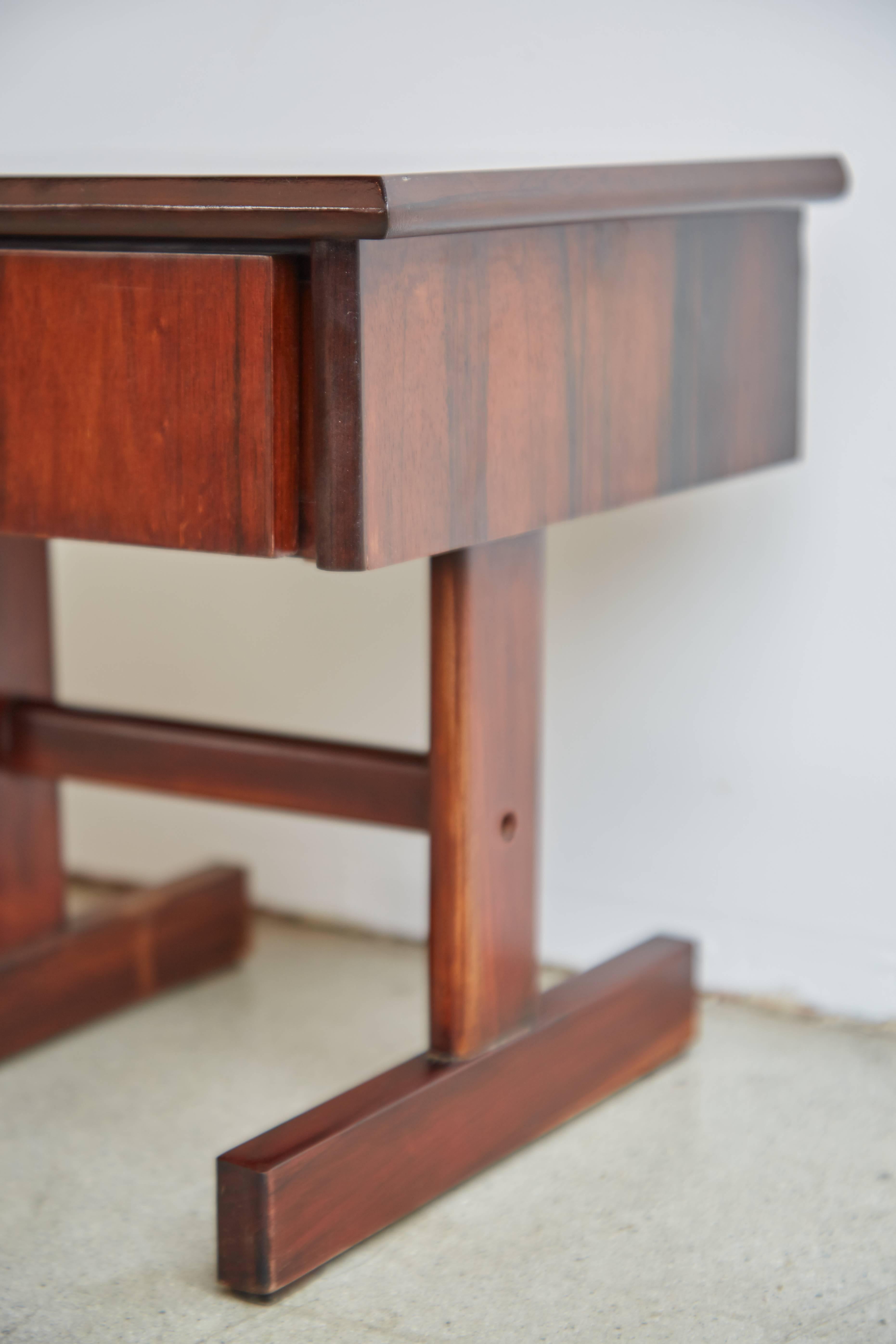 Pair (2) of restored nightstands or side tables fabricated from Brazilian Rosewood. These bijou pieces feature a clean, contemporary design and both include a single drawer which functions easily, perfect for small storage needs. 

The compact