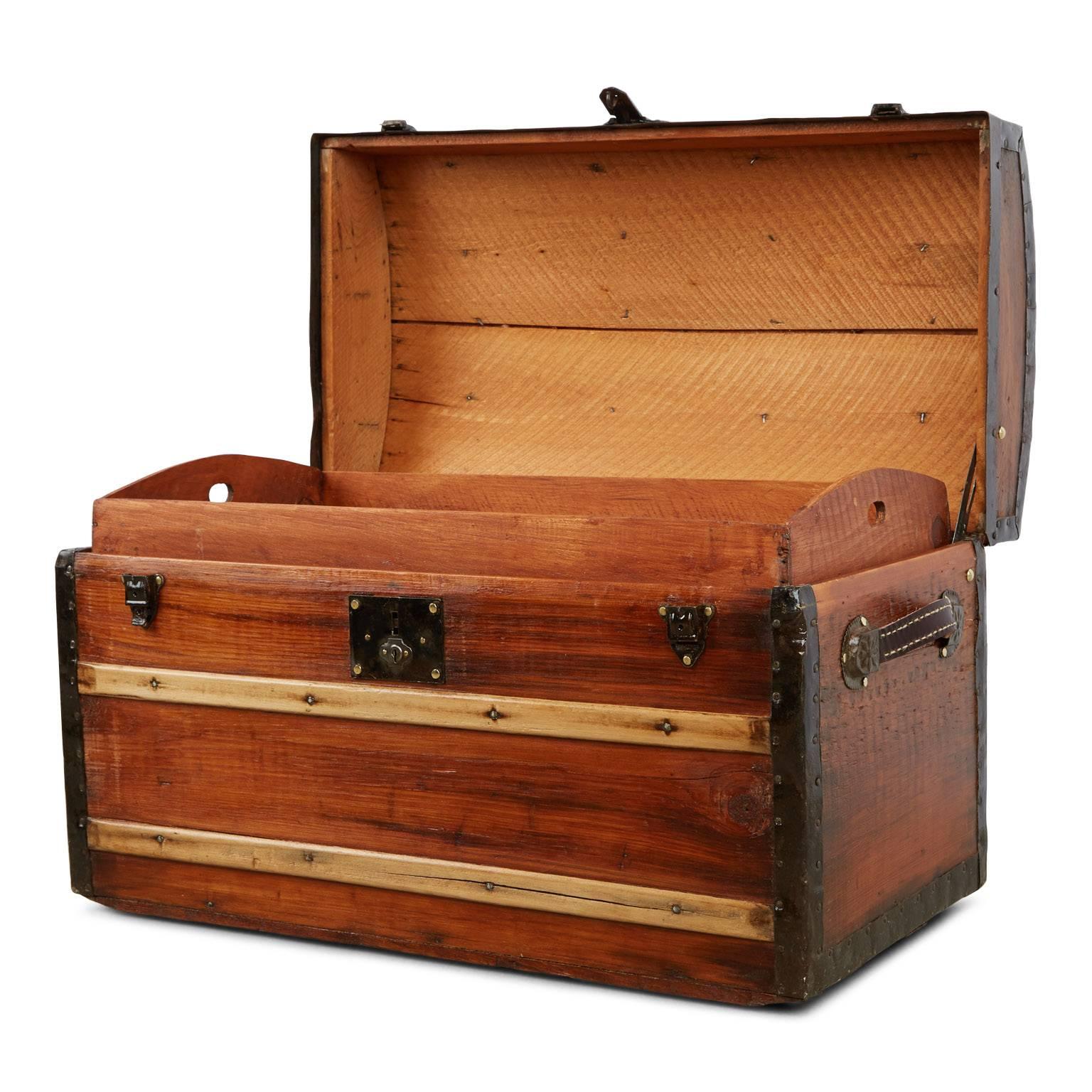 Beautifully restored mid-Victorian steamer trunk with dome top. Fabricated from oak planks which have been hand sanded and newly varnished inside and out, punctuated by contrast slats of fluted maple. This chest pertains all of the original cast