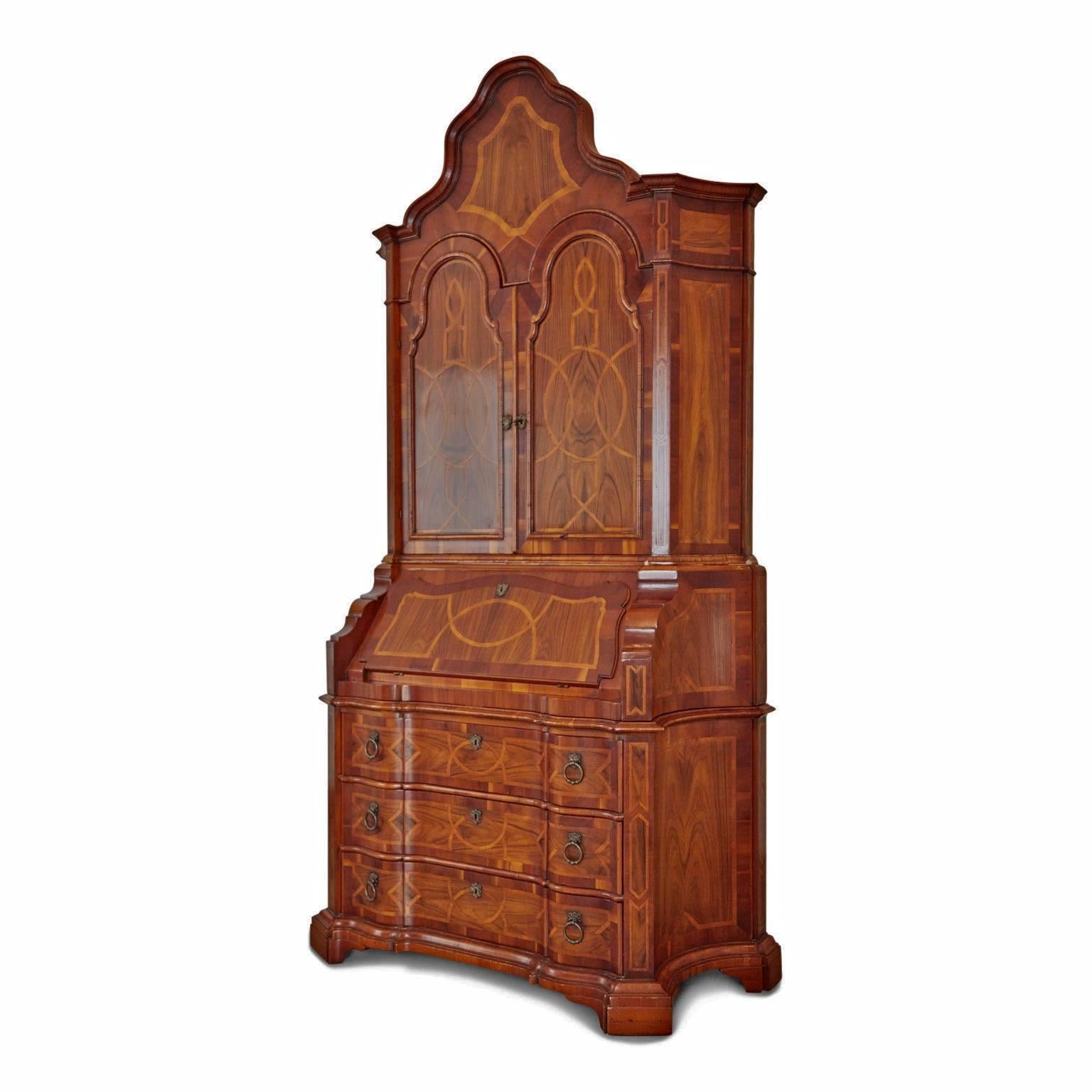 Impressive Italian Baroque style walnut secretaries or bureau that has been intricately inlaid, displaying expert craftsmanship and tonal wood. This grand piece is comprised of three (3) pieces that stack on top of each other. 

The upper half