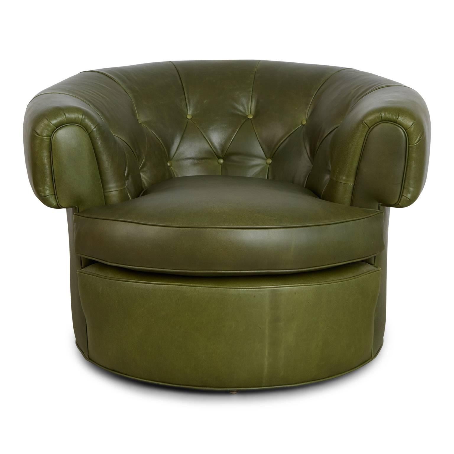 Handsome pair of Chesterfield style lounge chairs that provide a fresh twist on a design classic. These generously sized armchairs have been newly upholstered in forest green 'Old English' distressed leather that features an admirable on-trend