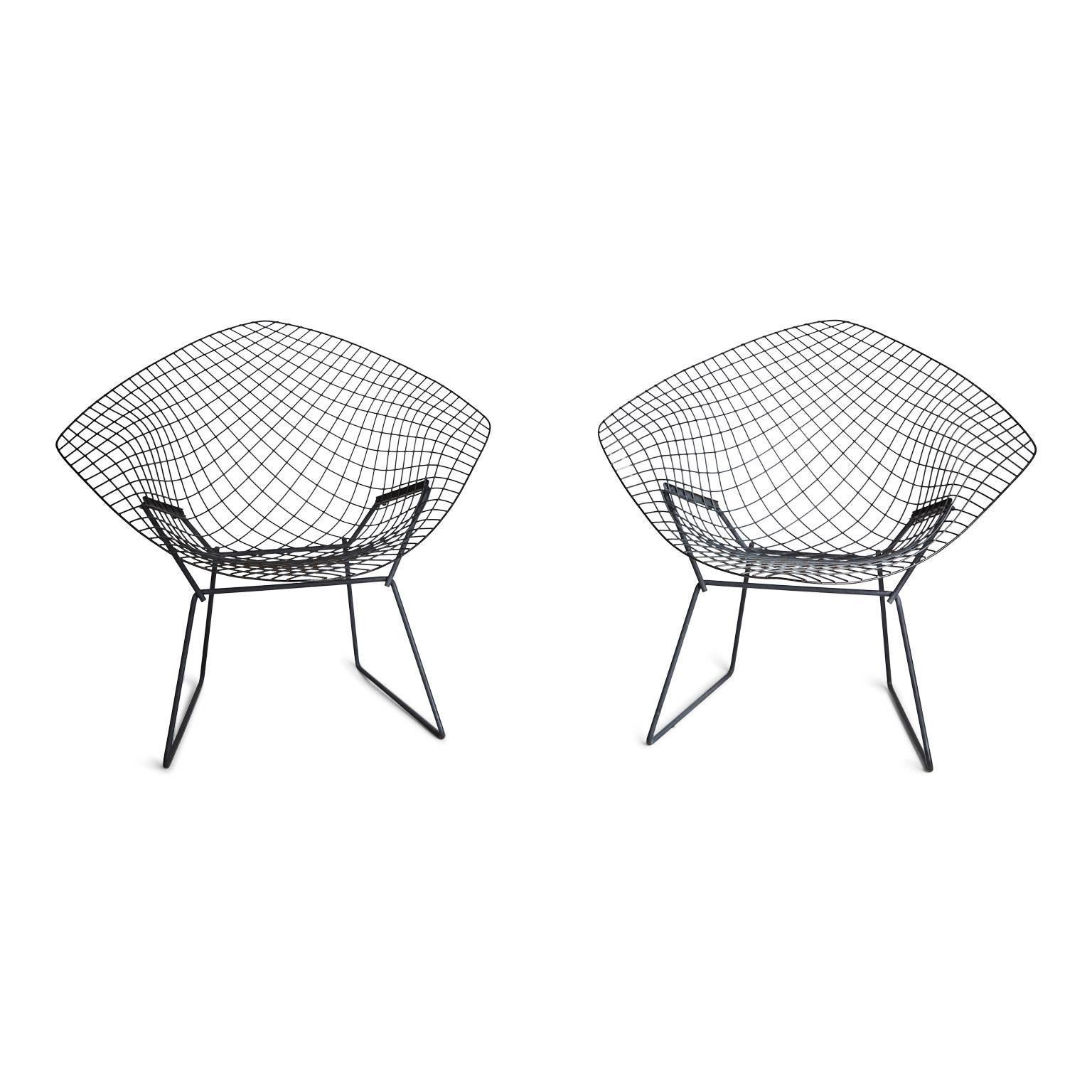 Since Harry Bertoia's Diamond chair was produced by Knoll in the 1950s these wire chairs have become one of the most iconic designs of Mid-Century Modernism. Both the pair of chairs and the matching ottoman are constructed of welded steel rods with