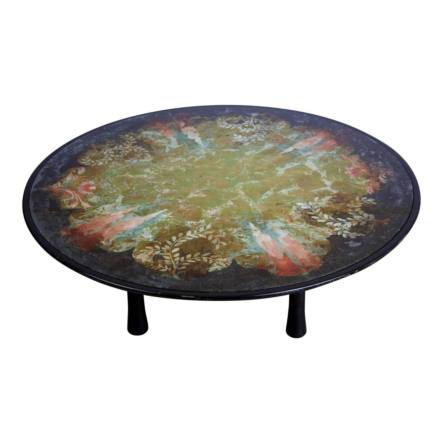 Extensively detailed, large and expansive Scandinavian verre églomisé coffee table supported by sculptural legs. The églomisé design is made applied onto the rear face of glass to produce a mirror finish. This includes an infusion of colors